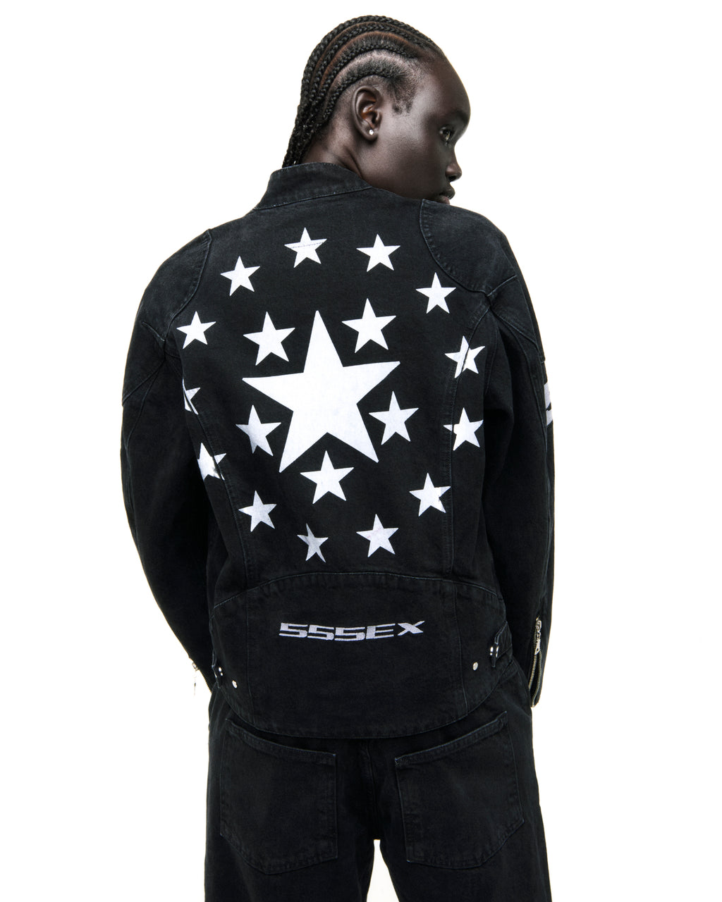 Faded black denim jacket with large white star on back, surrounded by smaller stars, and "SSSEX" embroidery.