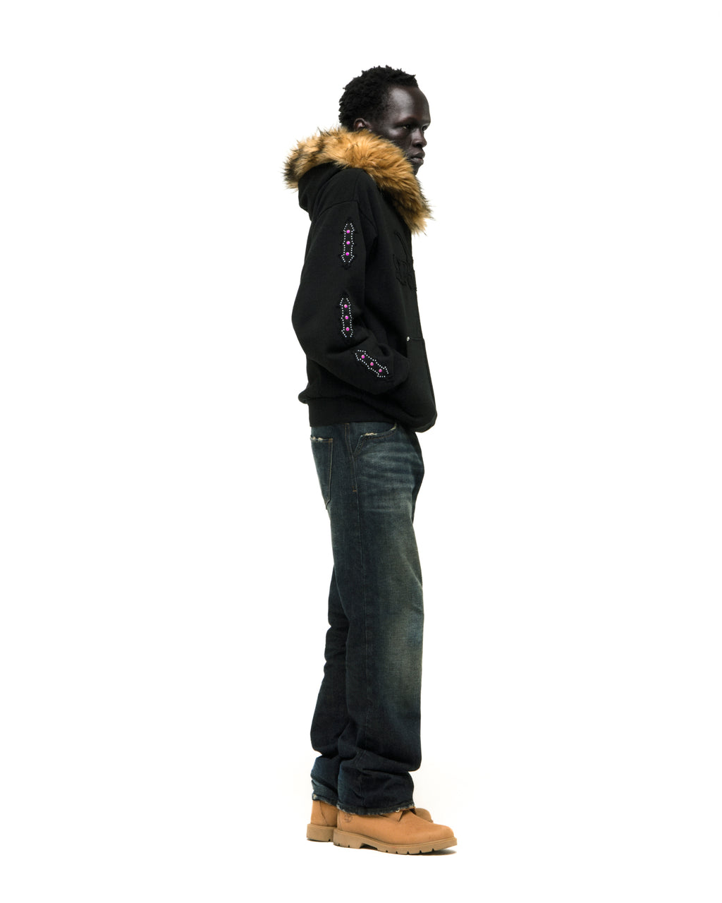 Black Garibaldi zip-up hoodie with faux fur hood trim, SP5DER text patches, and patterned sleeve accents.