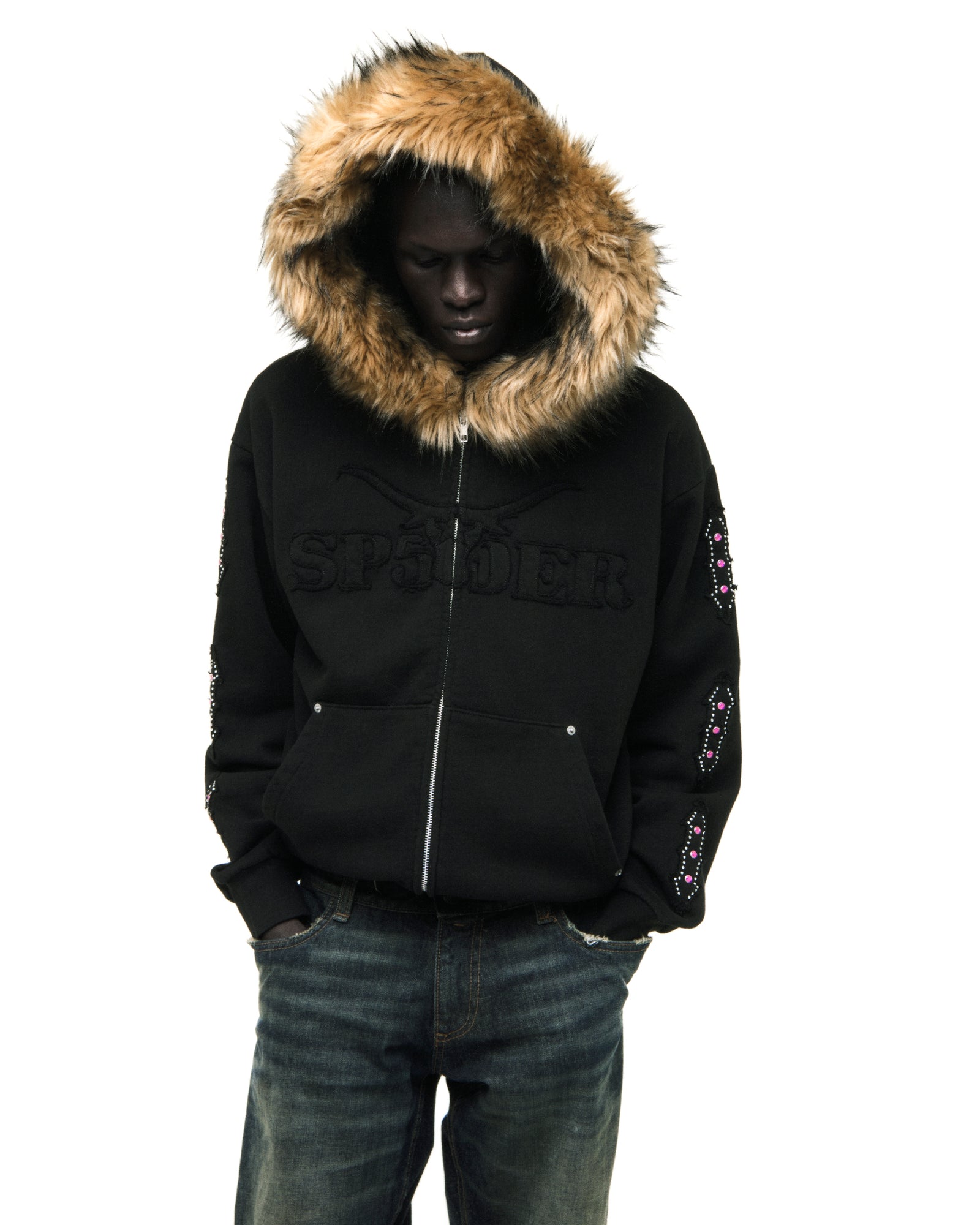 Black 13oz cotton fleece Garibaldi zip-up with faux fur hood trim, SP5DER text, patterned sleeves with stone appliqué, and studded pockets.