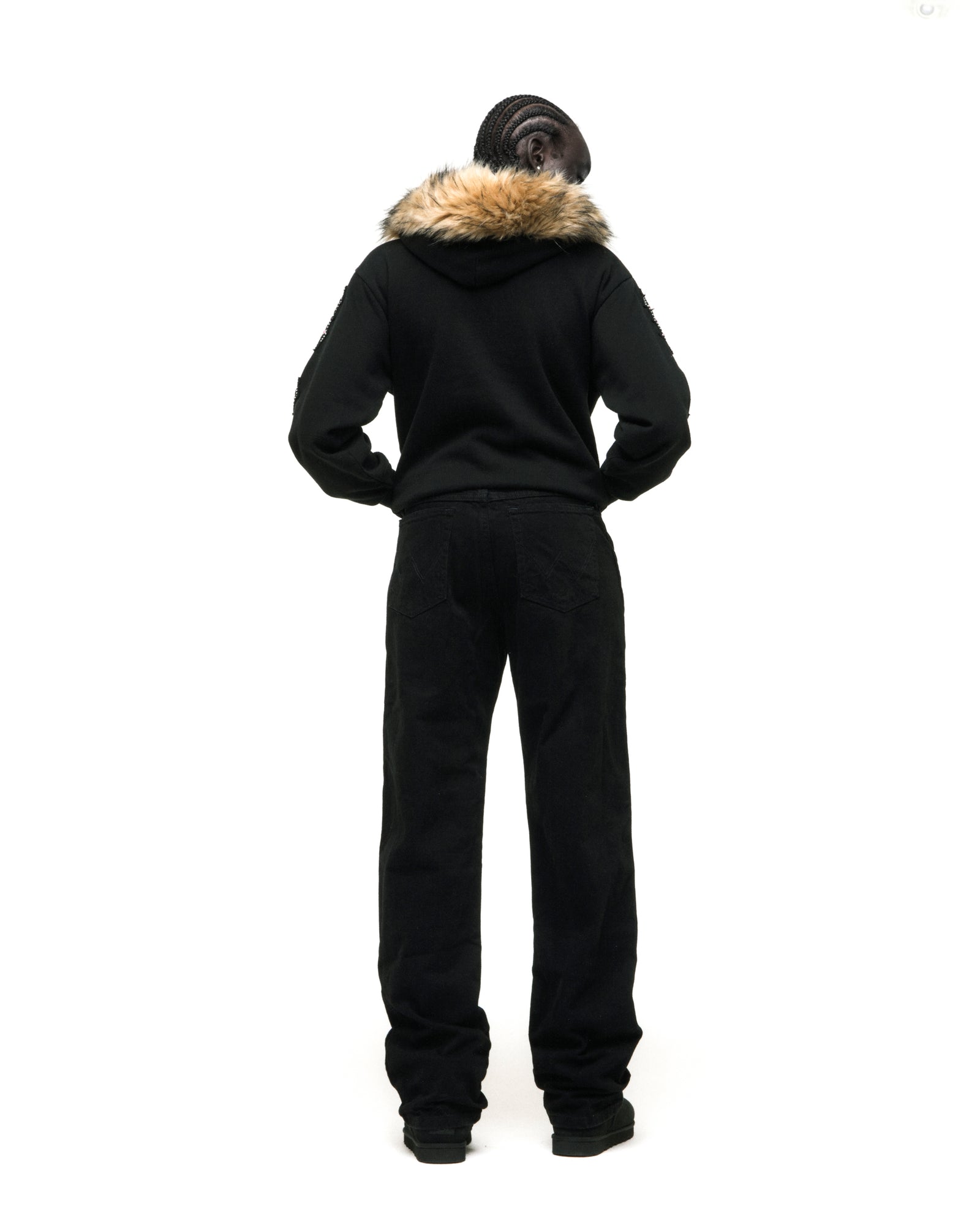 Black 13oz cotton fleece Garibaldi zip-up with faux fur hood trim, patterned sleeve accents, and studded pockets.