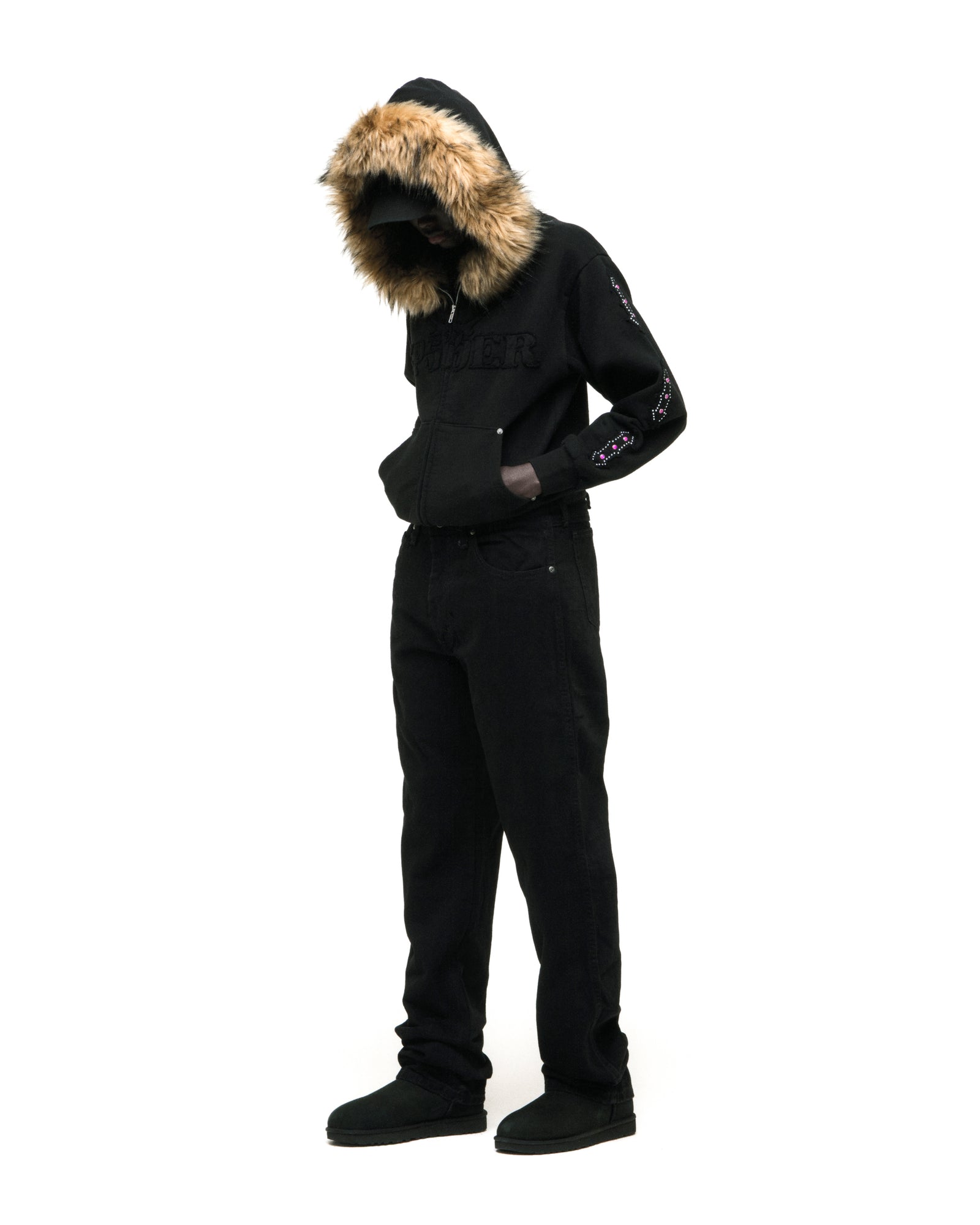 Black 13oz cotton fleece Garibaldi zip-up hoodie with faux fur hood trim, SP5DER text patches, patterned sleeve accents, and studded pockets.