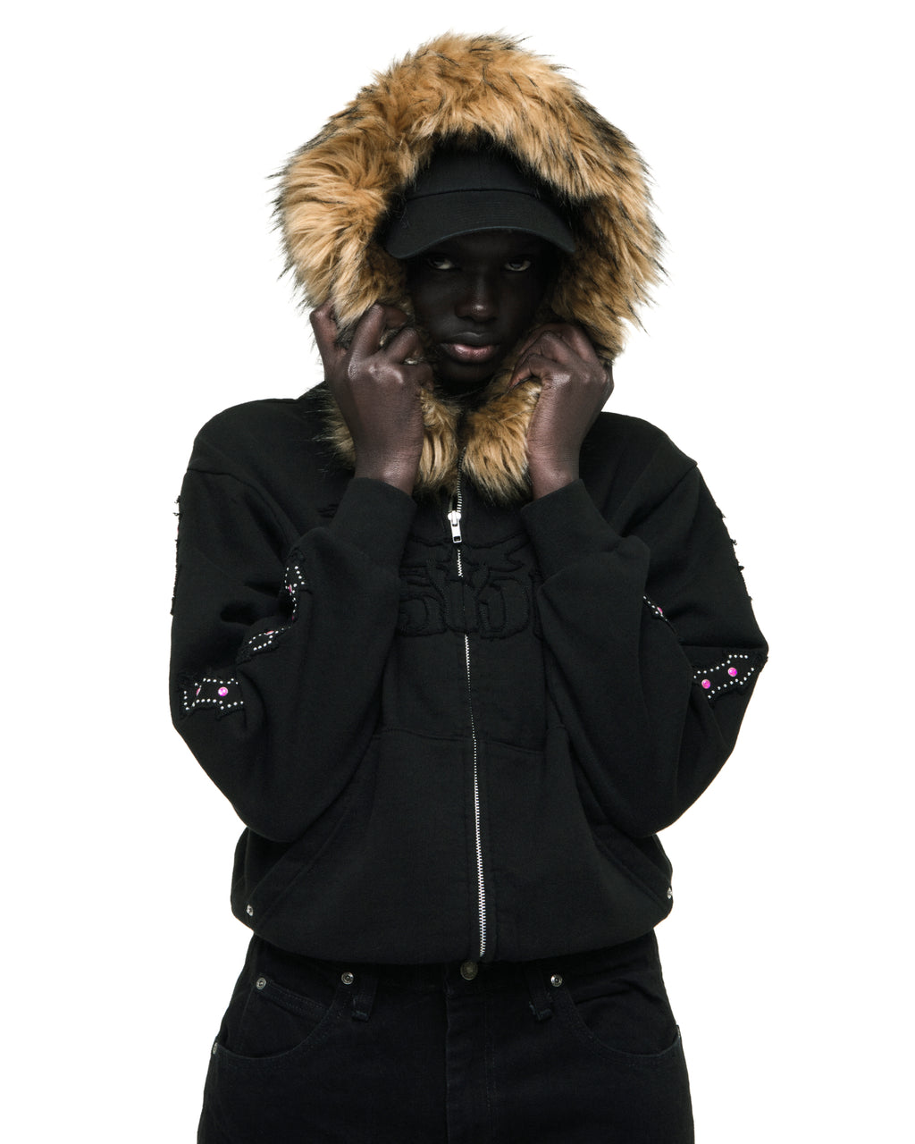 Black 13oz cotton fleece Garibaldi zip-up with faux fur hood trim, SP5DER text patches, patterned sleeves with stone appliqué, and studded pockets.