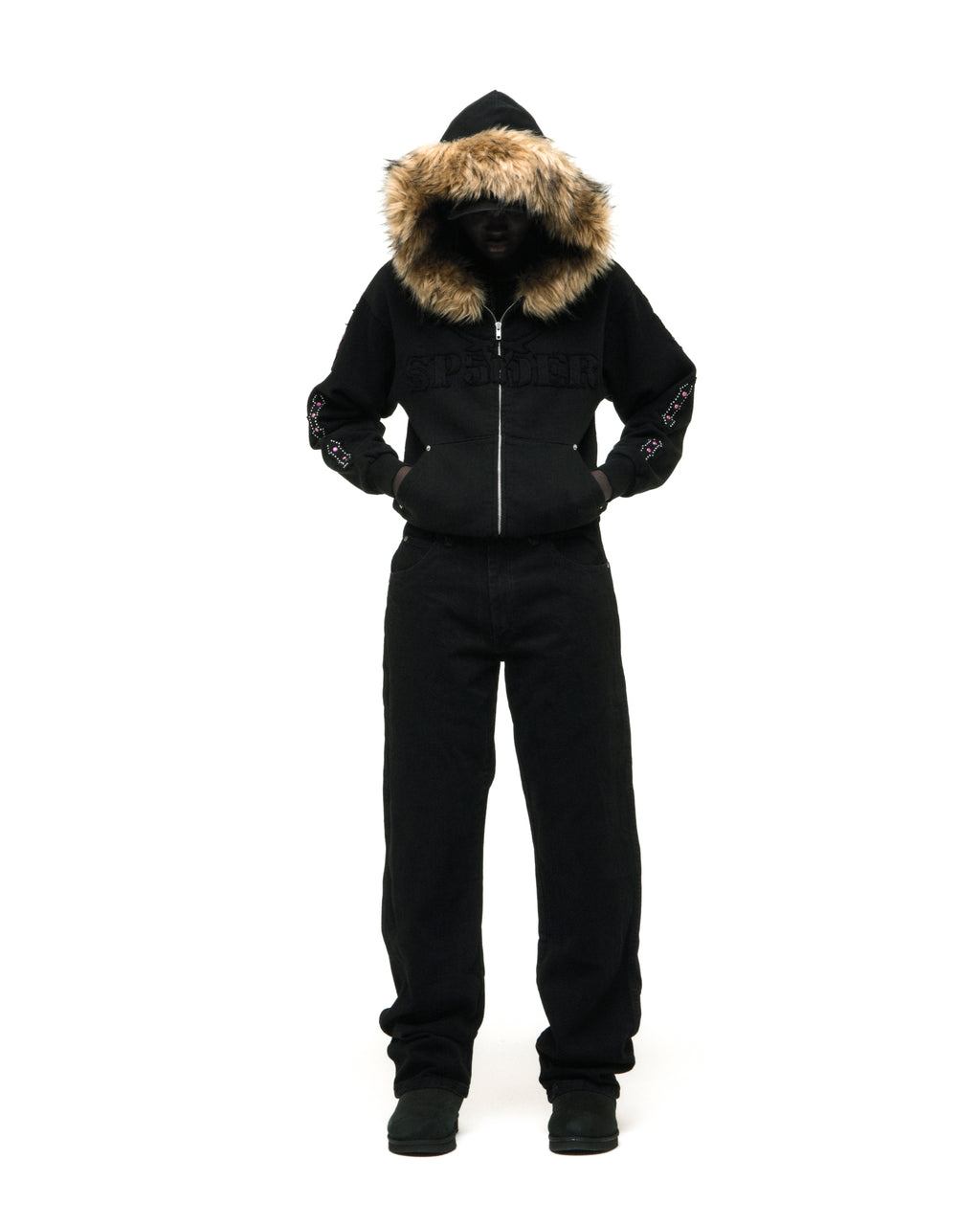 Black 13oz cotton fleece Garibaldi zip-up with faux fur hood trim, SP5DER text patches, patterned sleeve accents, and studded pockets.