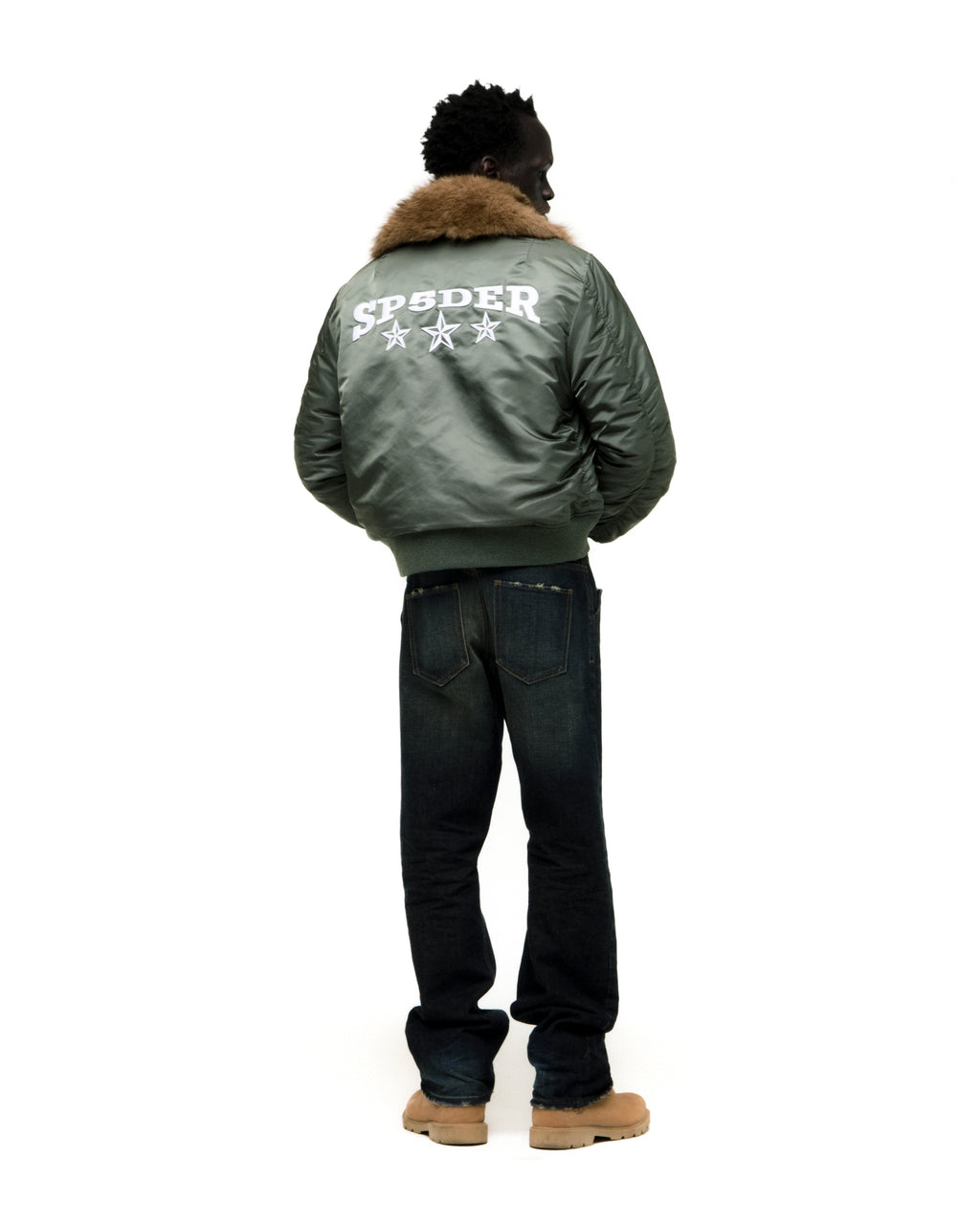 Back of a model wearing a green nylon bomber jacket with a faux fur collar and white SP5DER star graphic.