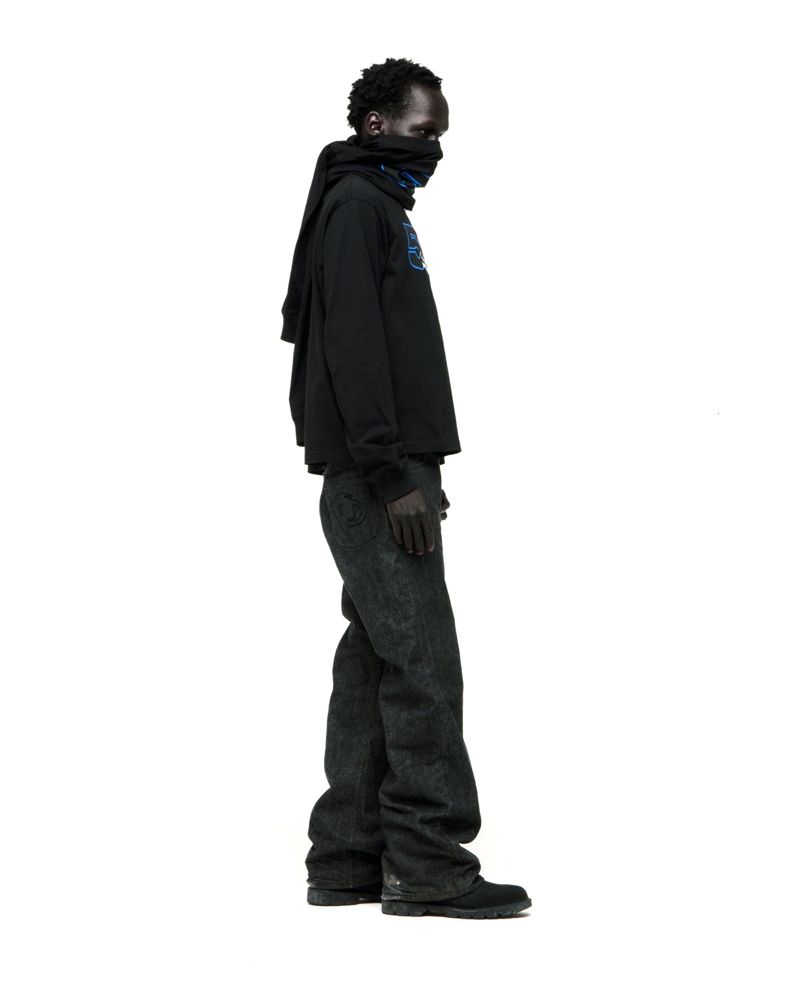 Black 555 SP5DER long sleeve tee with blue graphic, worn by a model in dark jeans.