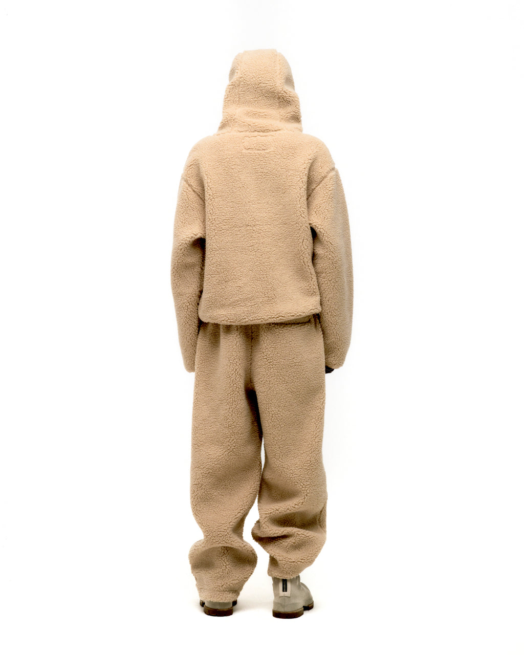 Back view of a beige sherpa fleece hooded zip-up jacket and matching sweatpants.