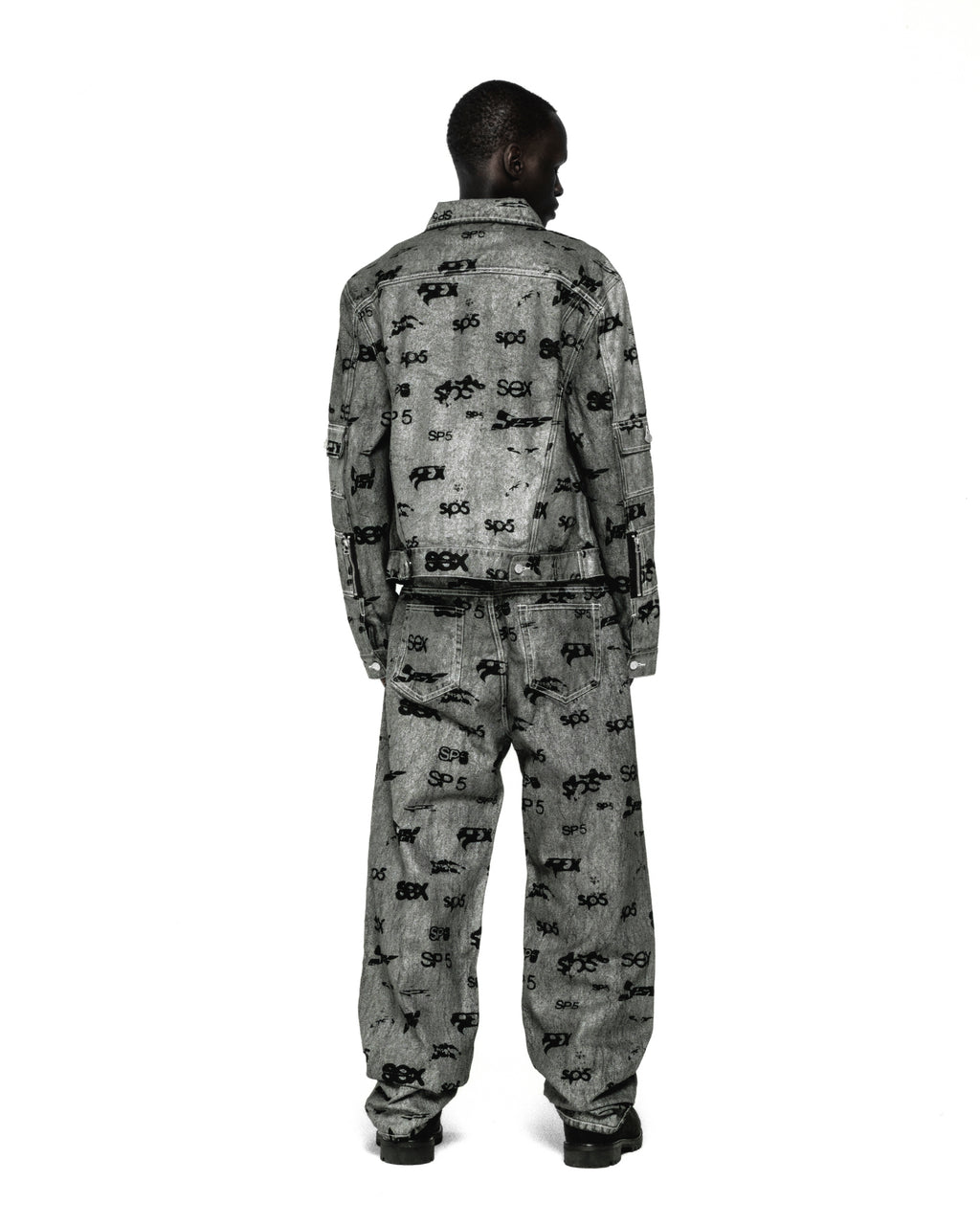 Model from behind wearing a grey denim trucker jacket and matching jeans with an all-over "SEX" print.