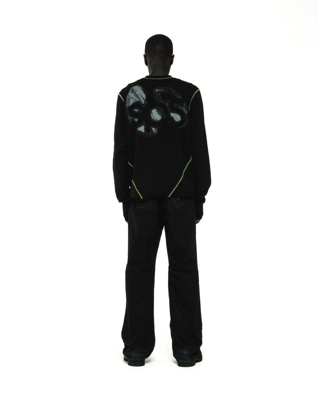 Black cotton long sleeve tee with green contrast stitching and graphic print on back.