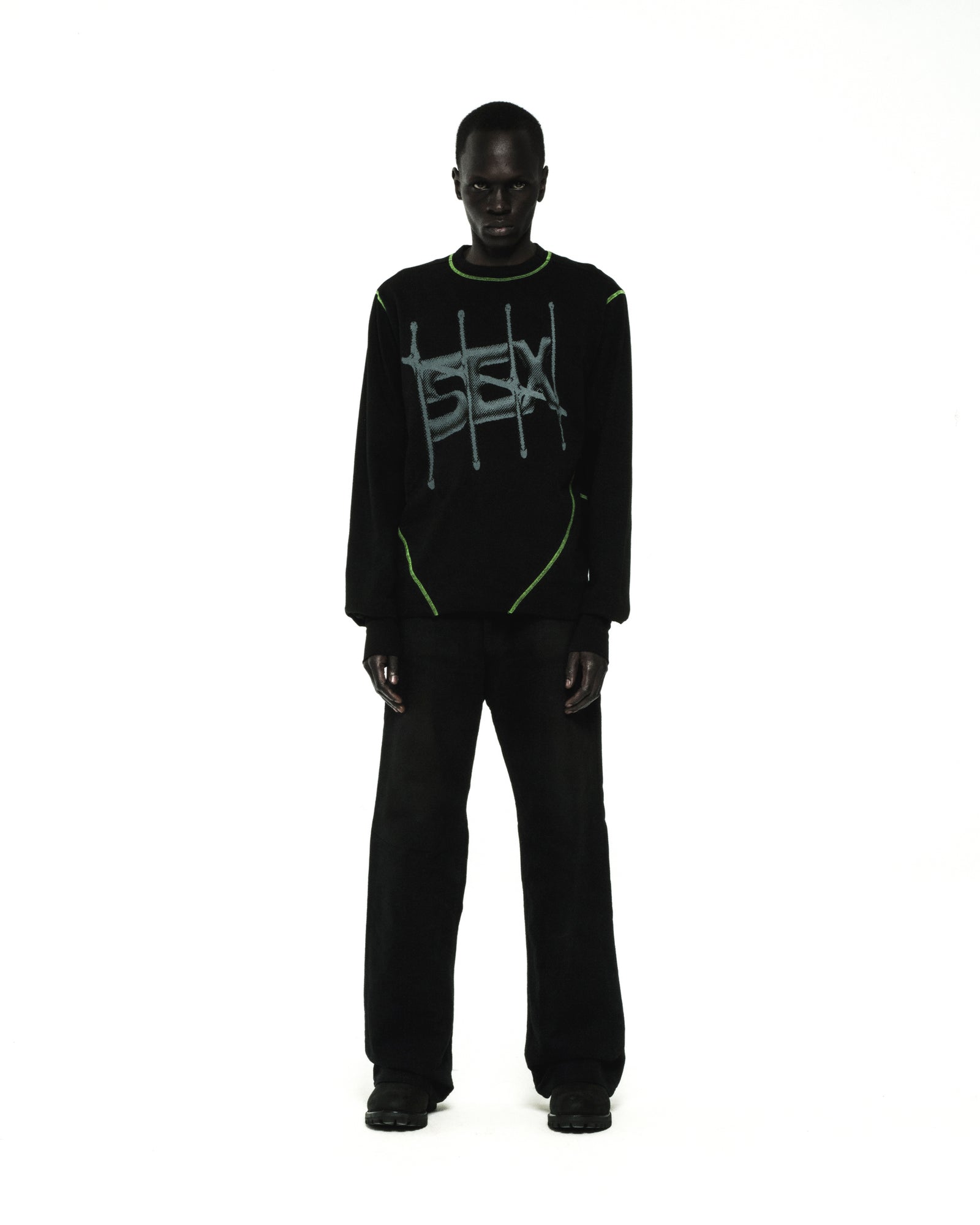 Black cotton SHADOWBANNED LONGSLEEVE with green contrast stitching and graphic print.