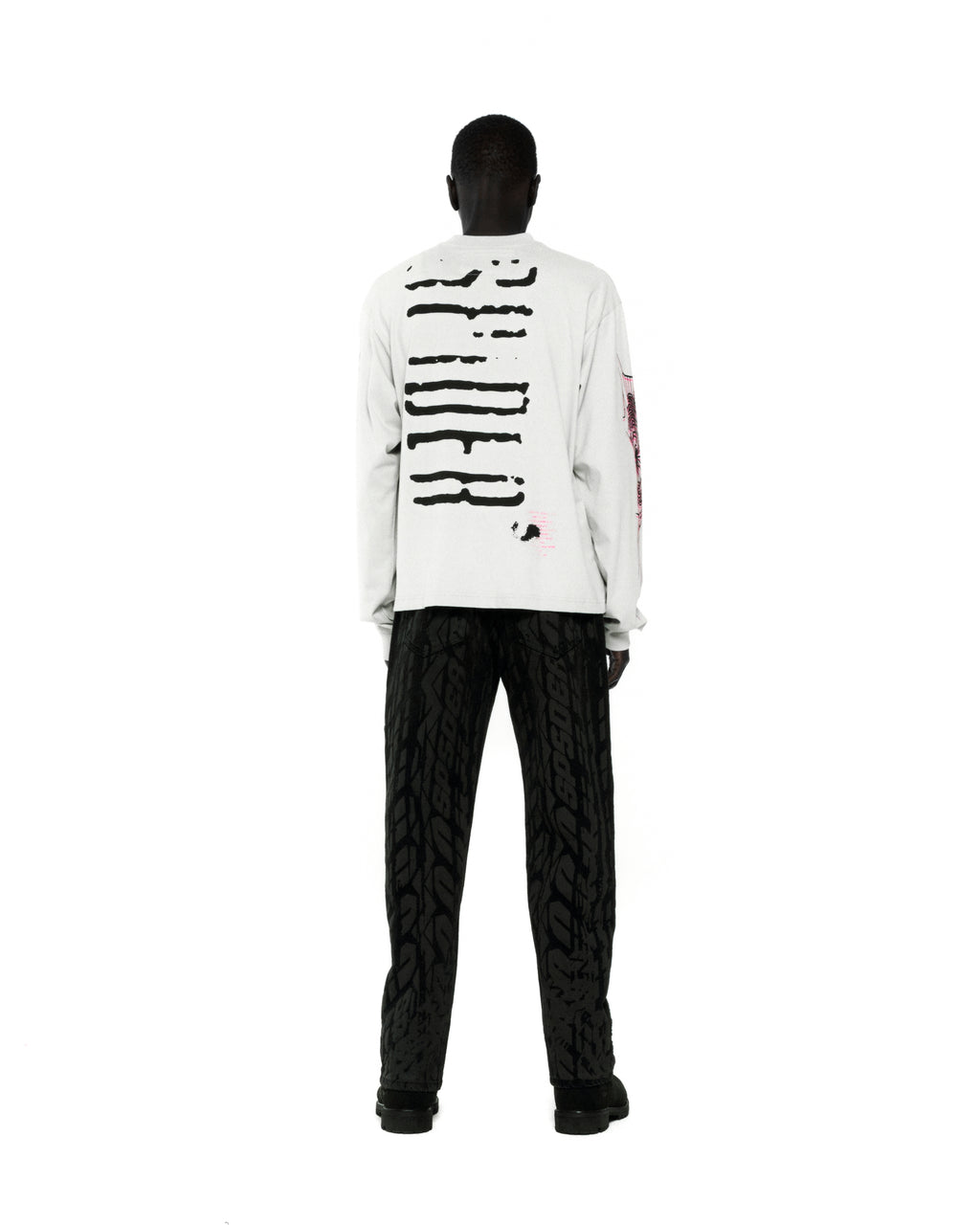 White 100% cotton long sleeve tee with black graphic print on back and sleeves.