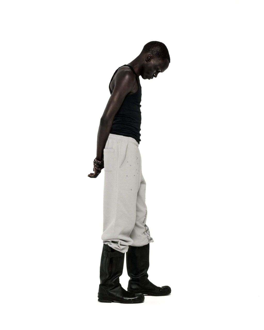 Light grey cotton fleece sweatpants with "P*NK SP5DER" text and scattered star print.