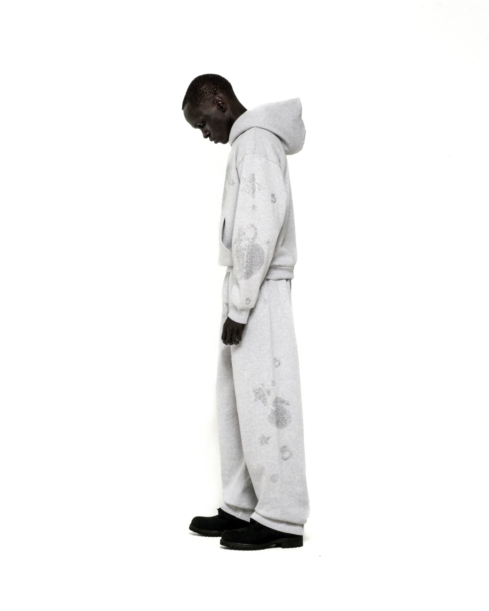 Light grey rhinestone-embellished cotton fleece hoodie and sweatpants set with 'SP5DER' and star designs.
