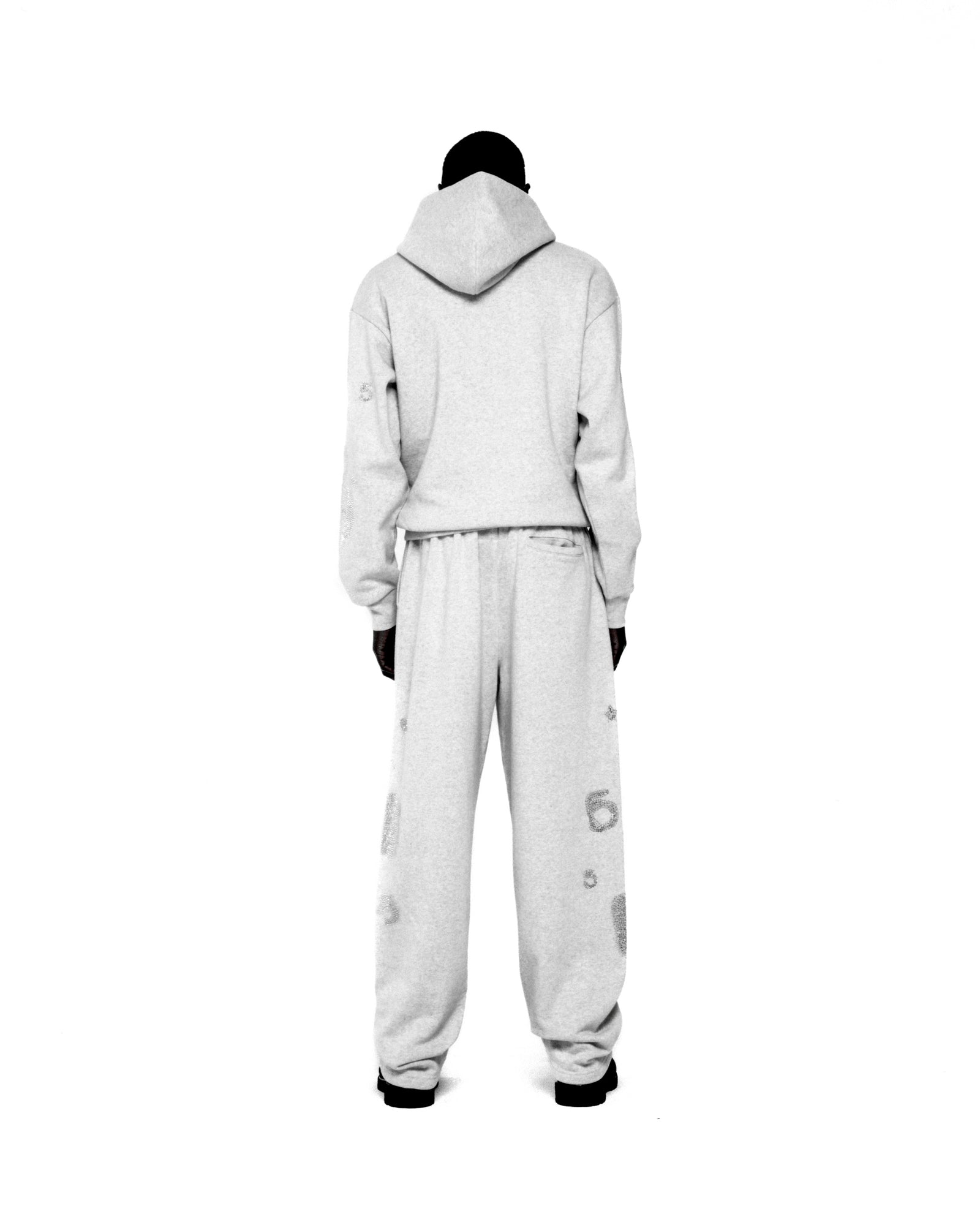 Light grey rhinestone embellished hoodie and sweatpants set with 'SP5DER' and star design.