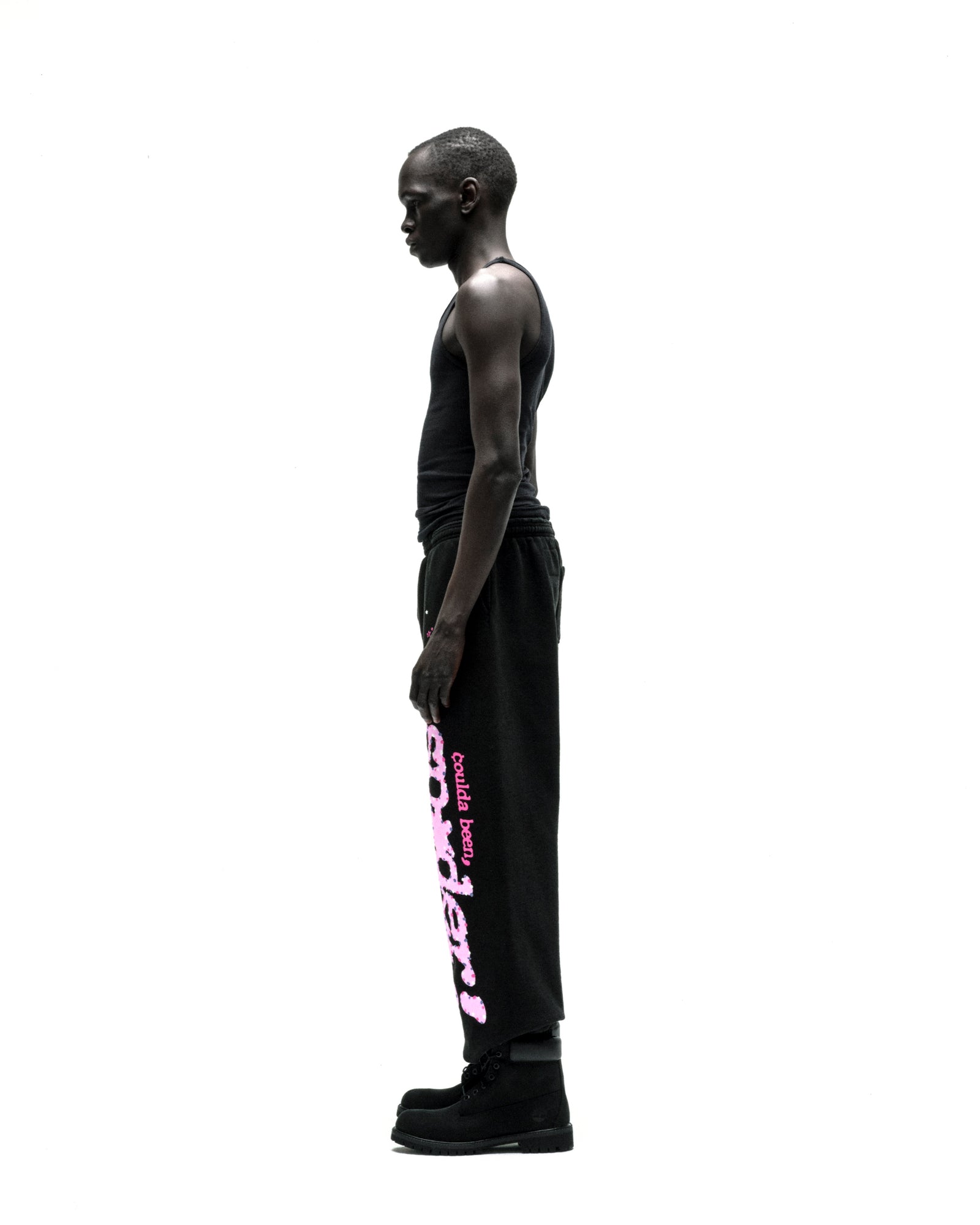Black CB PUNK V2 sweatpants with pink puff print "Could've been better" text down the leg, worn by a man.