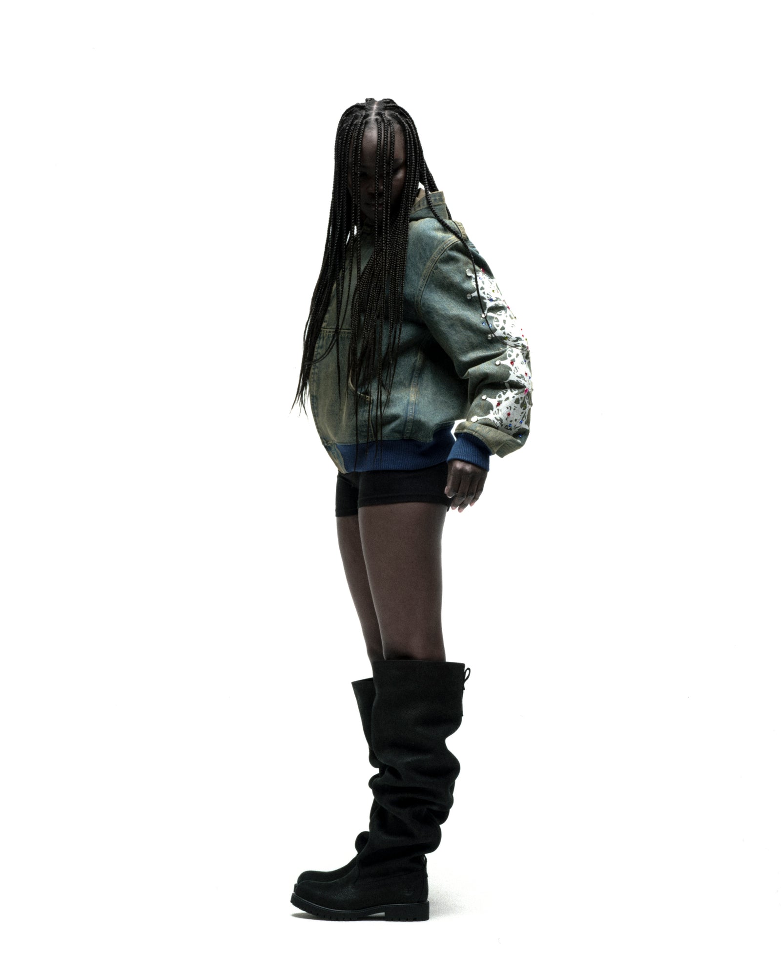 Faded denim hooded jacket with web print, rhinestone sleeves, zip closure, and patch pockets.