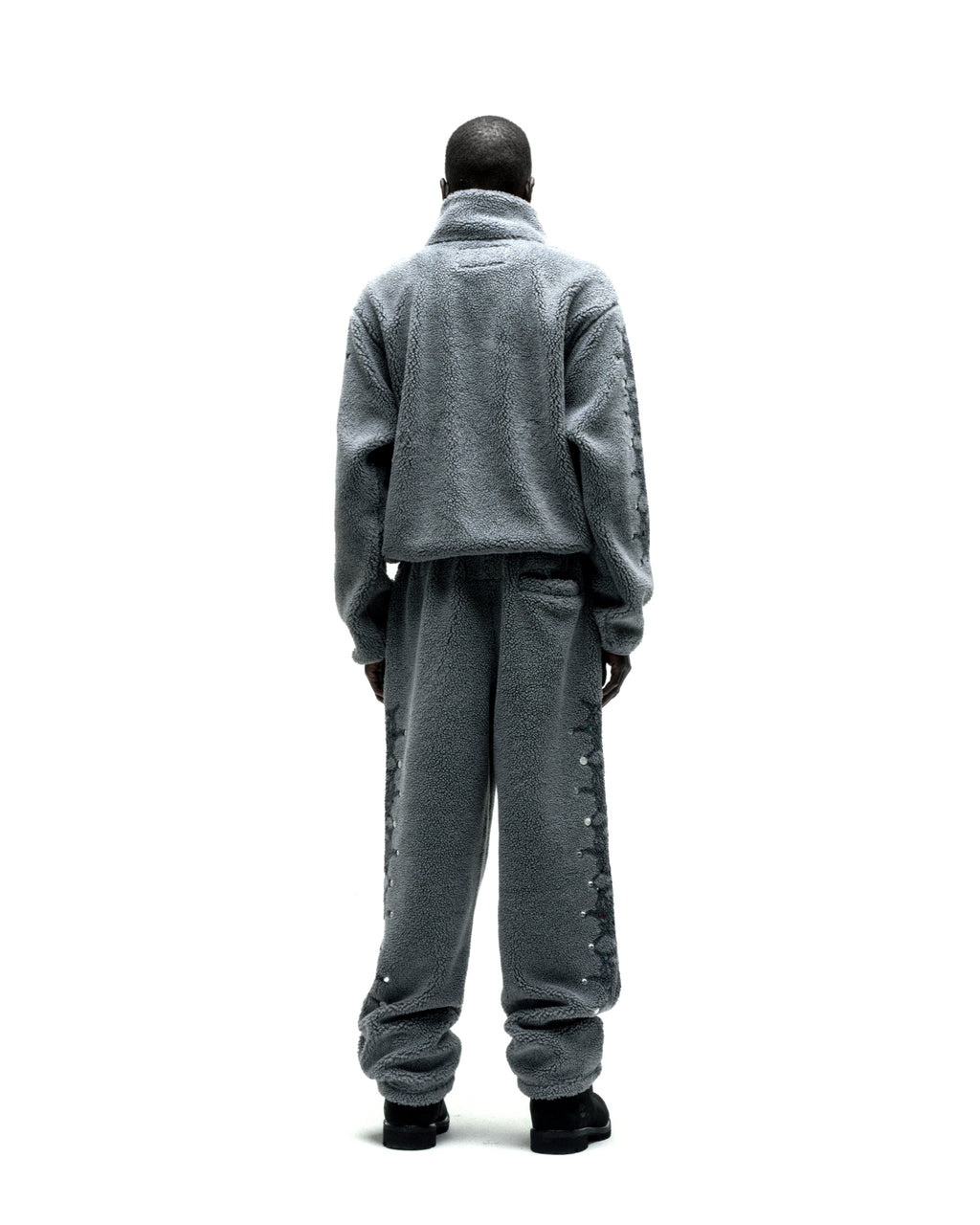 Gray sherpa fleece zip-up jacket and matching pants with web print and rhinestone sleeves.