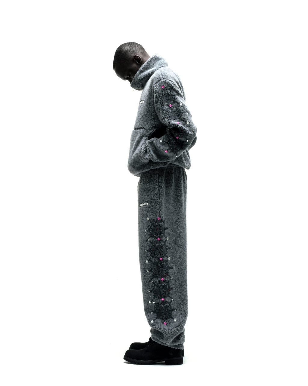 Gray sherpa fleece zip-up jacket and sweatpants with black web print and pink rhinestone embellishments.