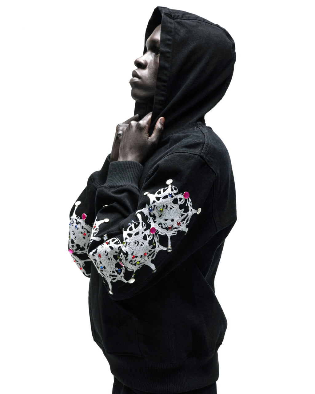 Black cotton canvas hooded jacket with web print and rhinestone embellishments on sleeves.
