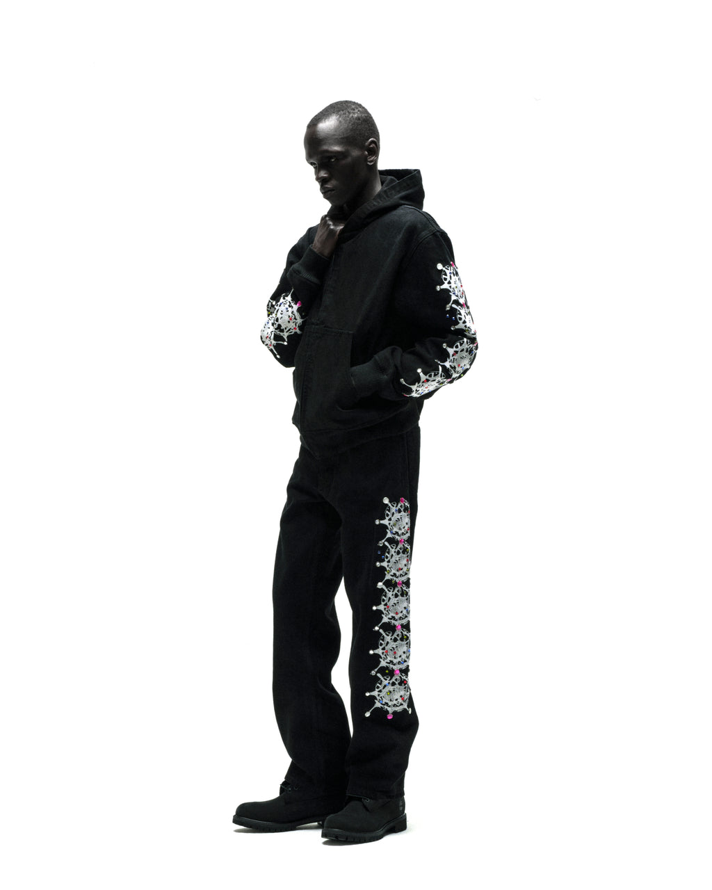 Black cotton canvas hooded jacket with web print and rhinestone sleeves, paired with matching pants.