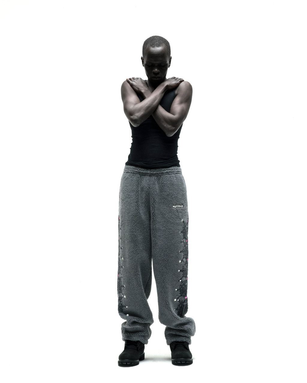 Gray sherpa fleece pants with rubberized logo, web print, and rhinestone embellishments.