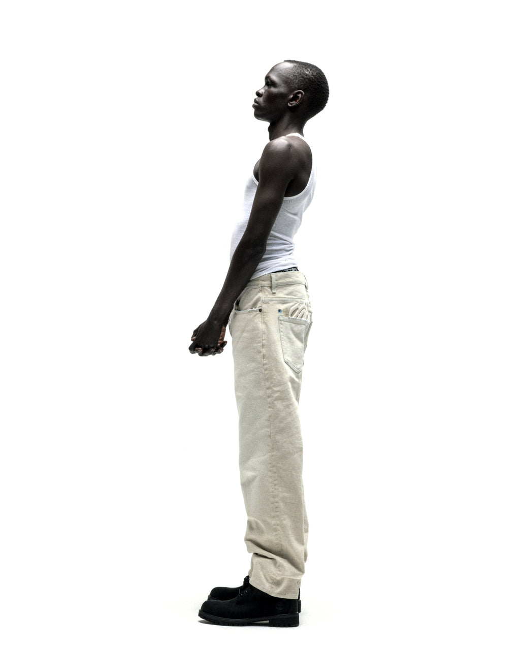 Man in OXY JEAN 13oz light beige denim pants with straight leg fit and custom hardware.