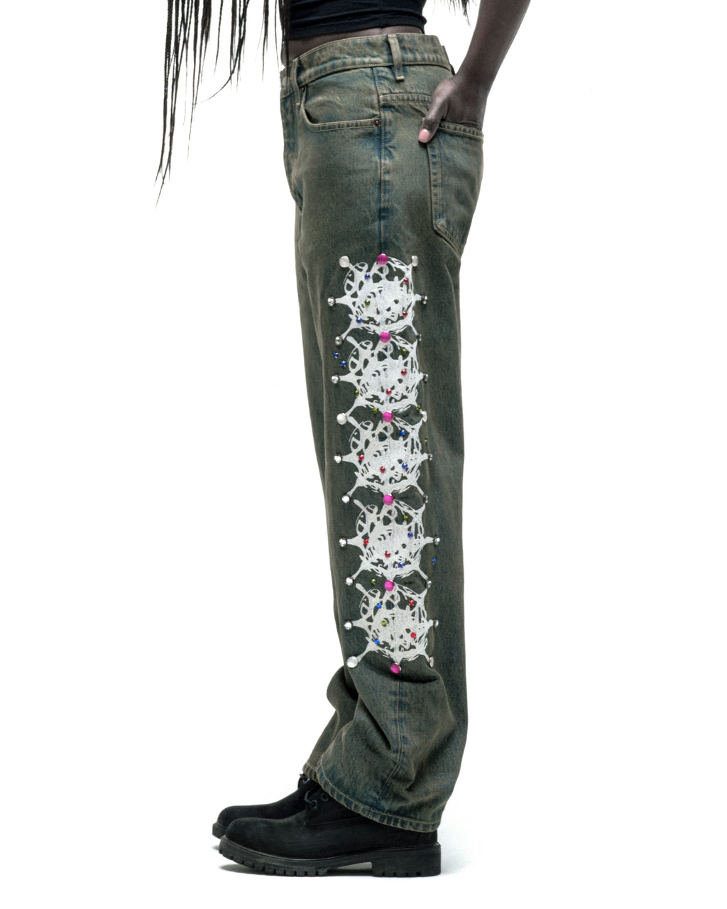 Vintage wash 13oz denim pants with white web print and colorful rhinestone embellishments down the leg.