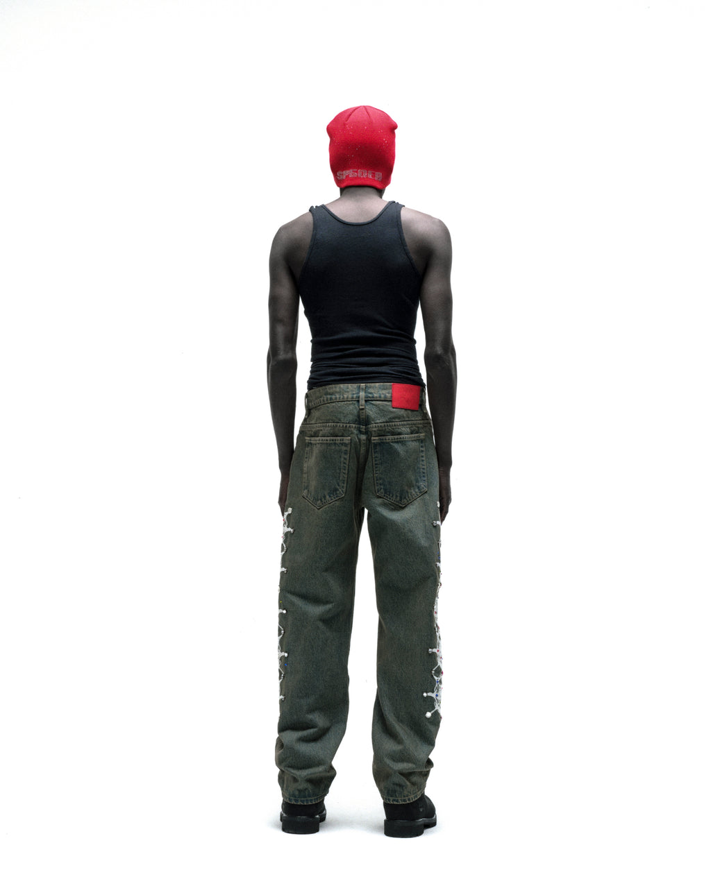 WEBSTONE DENIM vintage wash straight leg jeans with web print and rhinestone embellishments down both legs.