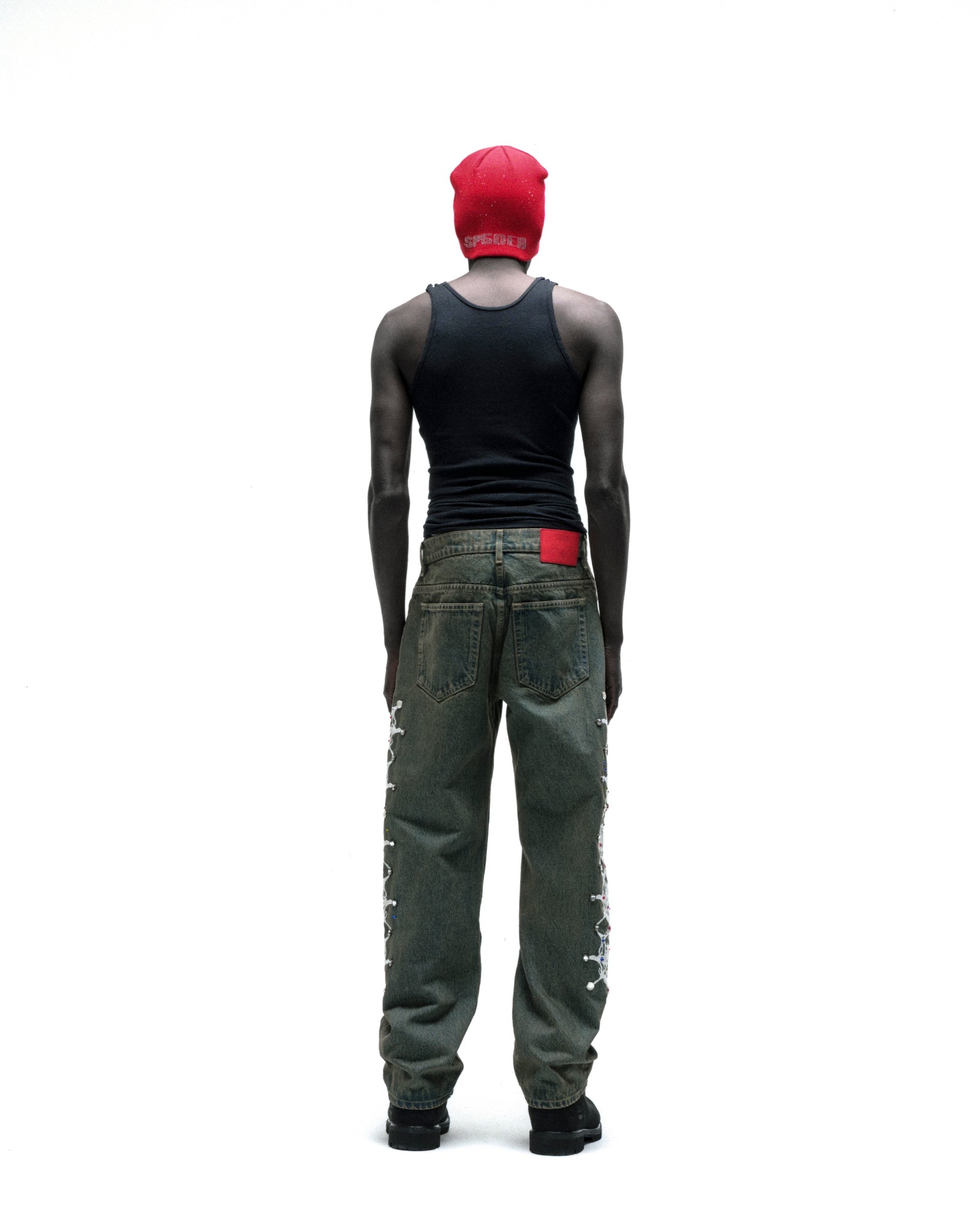 WEBSTONE DENIM vintage wash straight leg jeans with web print and rhinestone embellishments down both legs.