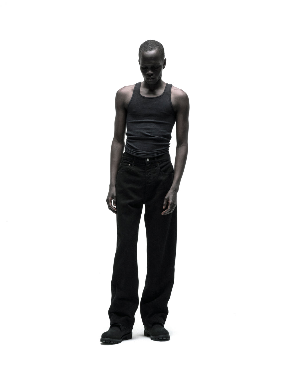 Model wearing OXY JEAN, black 13oz denim straight leg pants with branded hardware.
