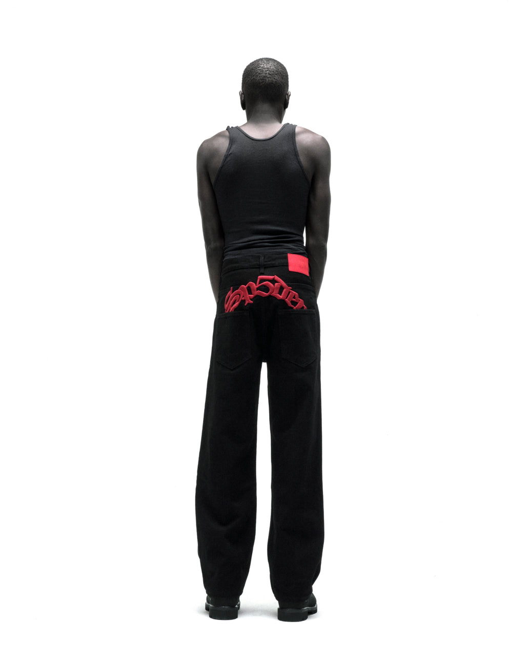 Black 13oz denim OXY JEAN with red embroidered text above back pockets and a red leather back patch.