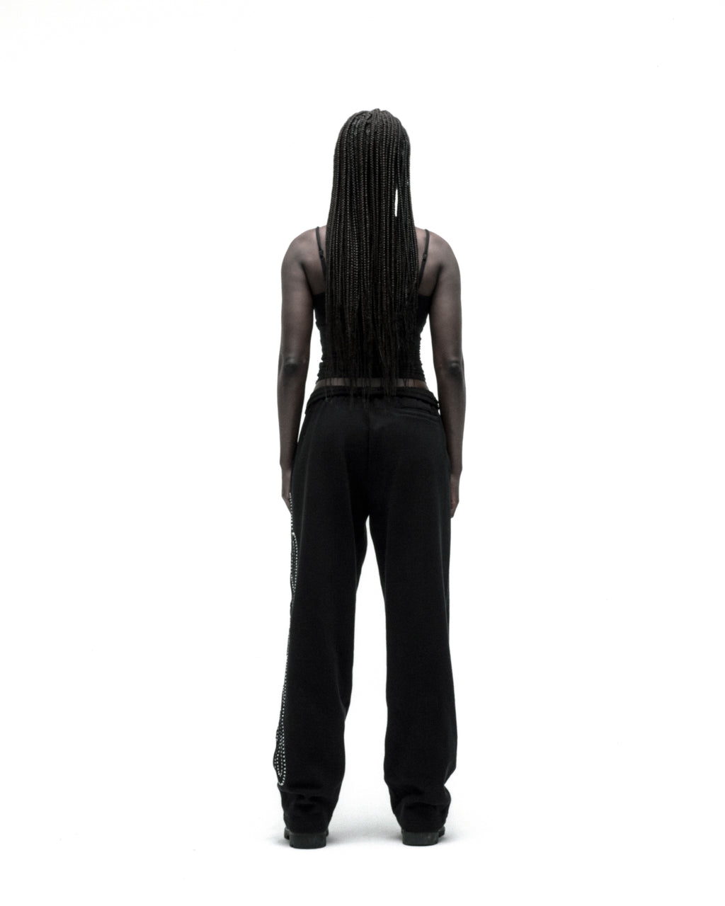 Black wide-leg cotton fleece sweatpants with rhinestone script down the leg.