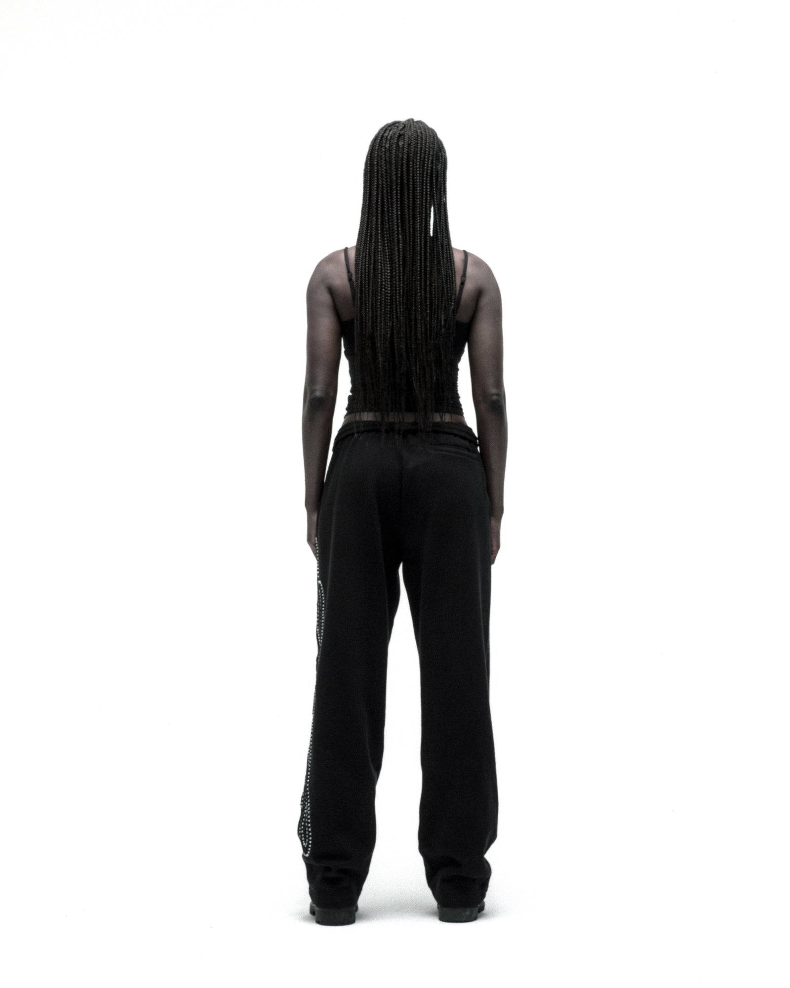 Black wide-leg cotton fleece sweatpants with rhinestone script down the leg.