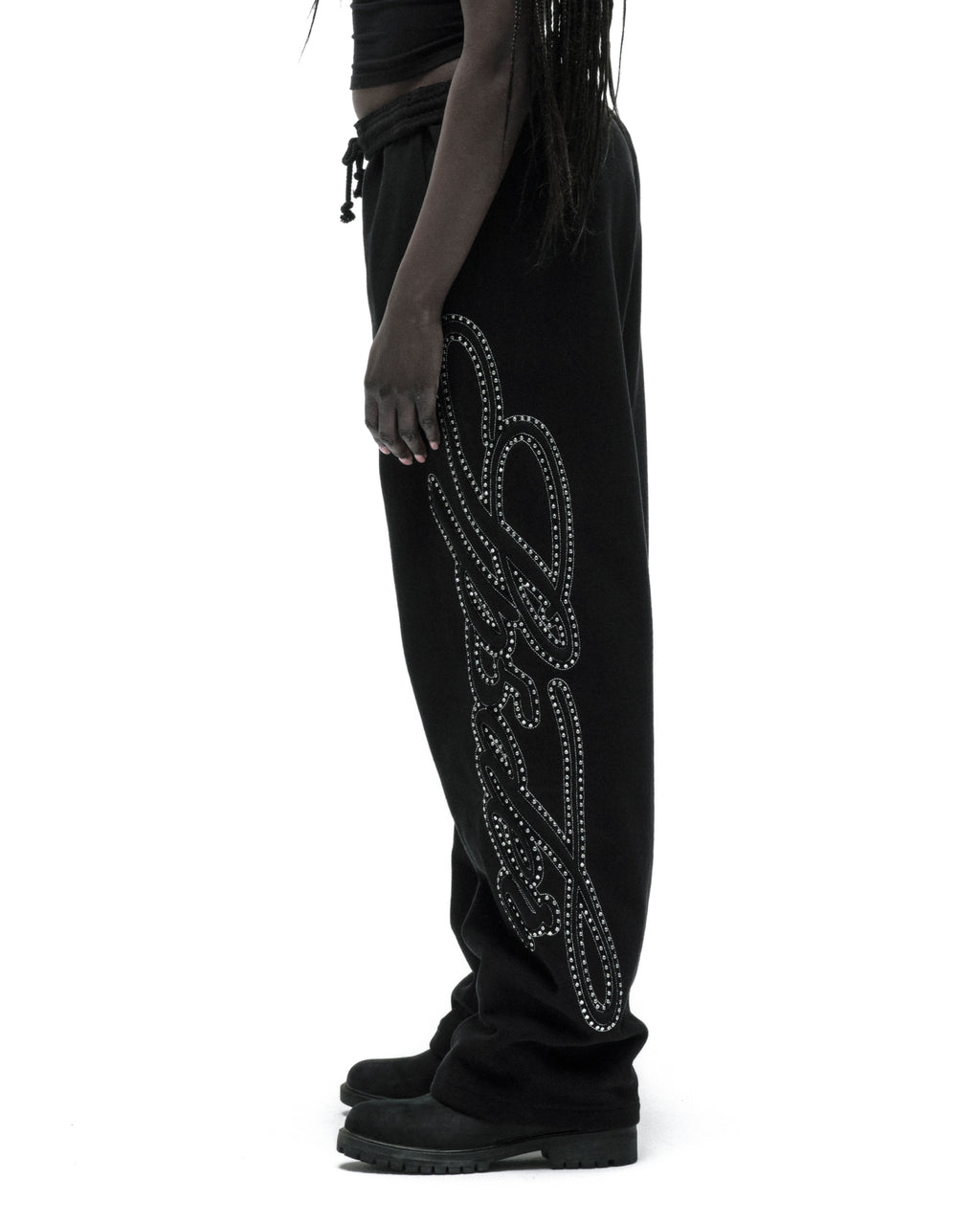 Black 100% cotton wide-leg sweatpants with rhinestone script text down the leg.