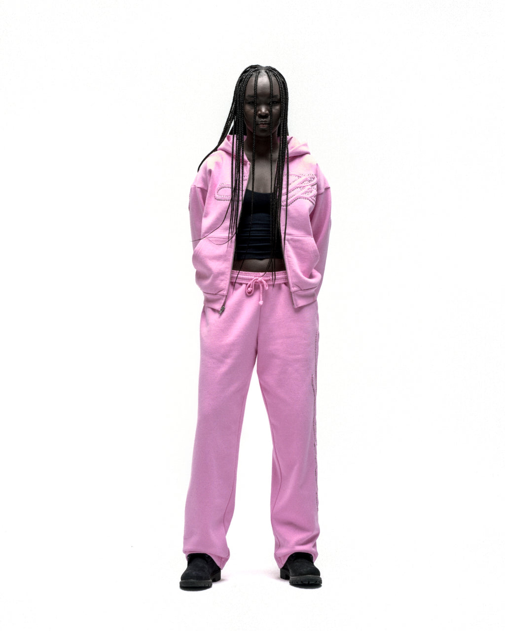 Pink rhinestone script zip hoodie and matching sweatpants on a model.