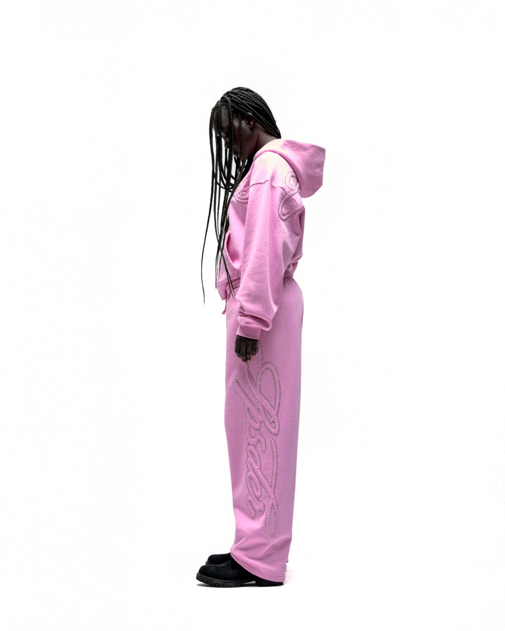 Pink rhinestone script zip hoodie and matching sweatpants on a model.