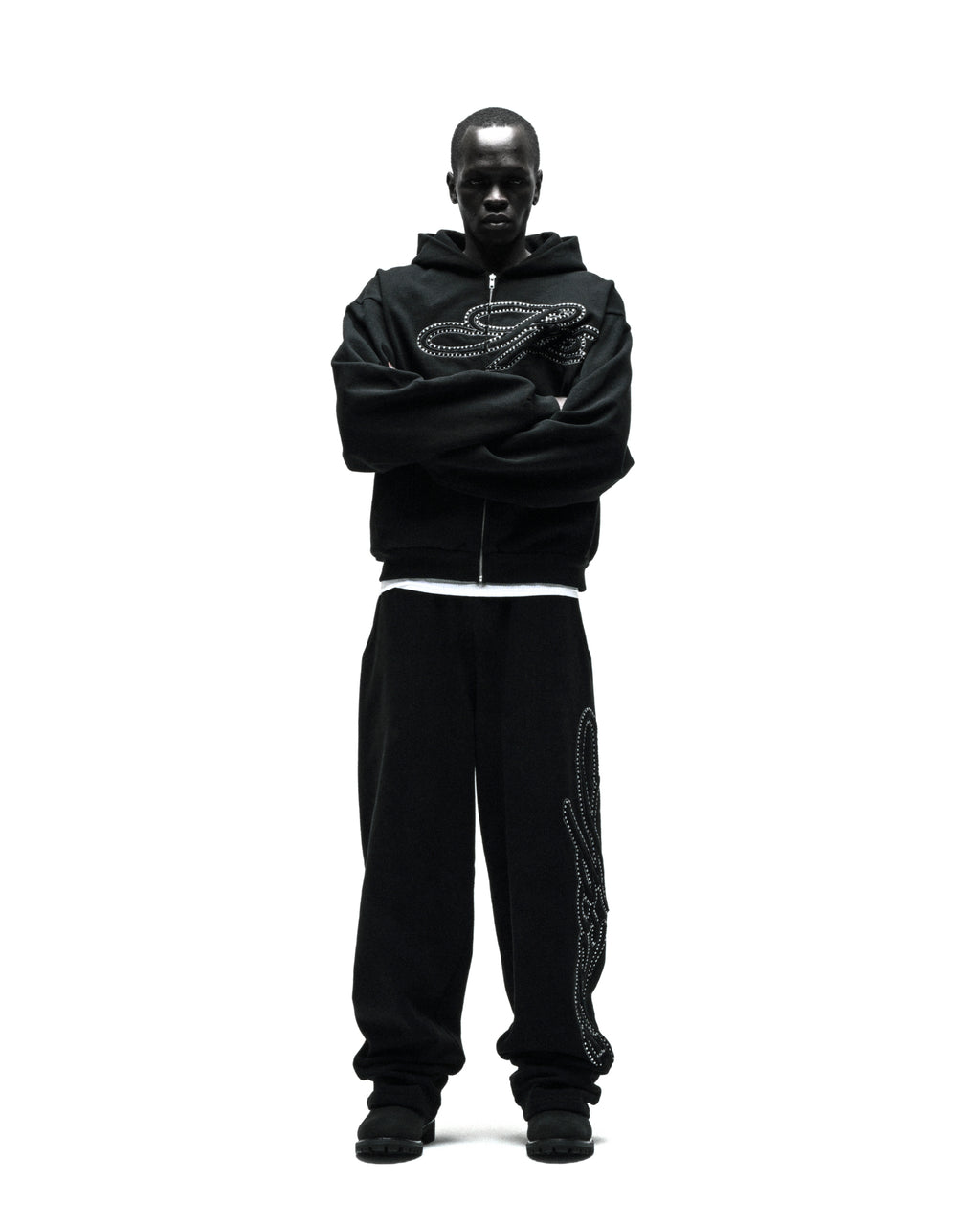Black 100% cotton wide-leg sweatpants with rhinestone script down the leg, paired with a matching hoodie.