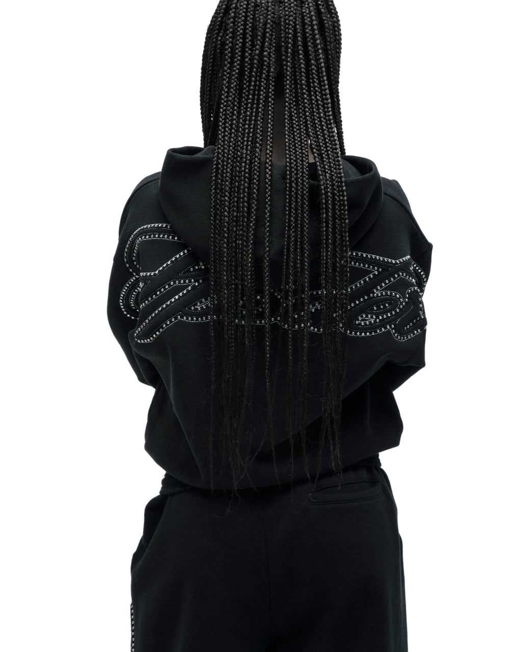 Black cotton fleece zip hoodie with rhinestone script on back, ribbed cuffs/waistband, and kangaroo pocket.