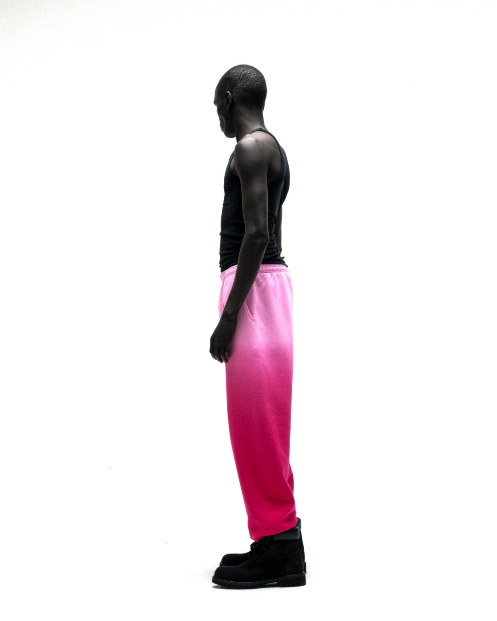 OG WEB OMBRE SWEATPANT: Pink ombre cotton fleece sweatpants with elasticized cuffs, worn by a man.