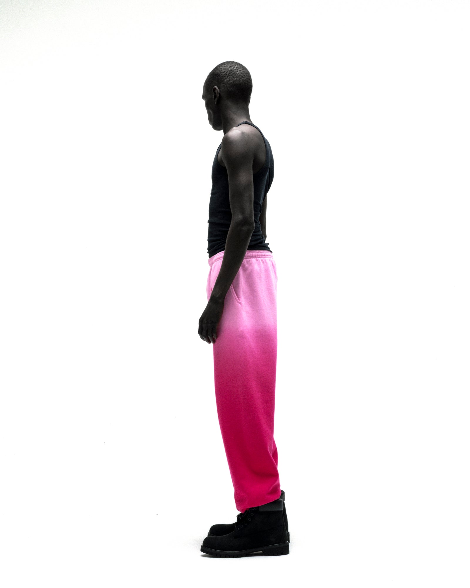 OG WEB OMBRE SWEATPANT: Pink ombre cotton fleece sweatpants with elasticized cuffs, worn by a man.