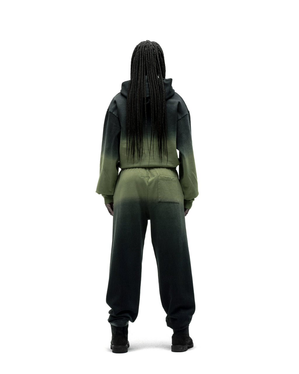 Model from behind wearing an OG WEB OMBRE SWEATPANT set with a dark green to light green ombre design.