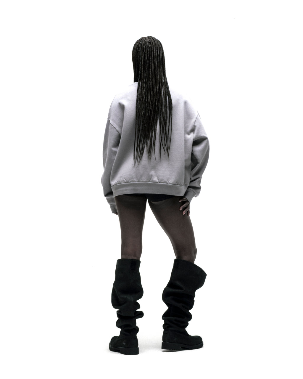 Back view of a person wearing an oversized light grey SP5DER CUNTRY CREWNECK sweatshirt.