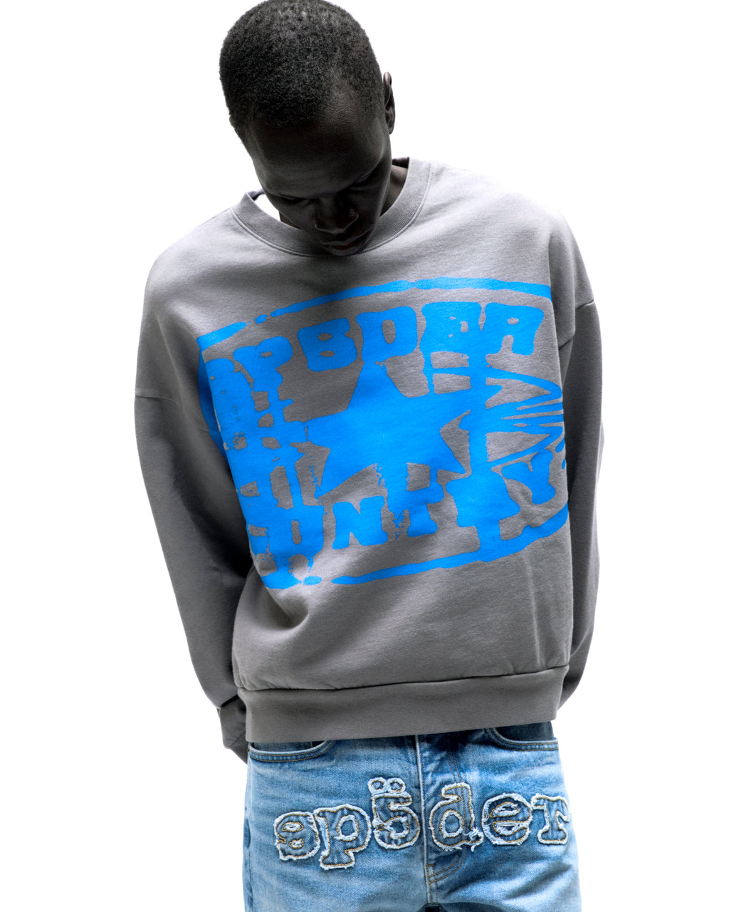 Gray SP5DER CUNTRY CREWNECK with blue graphic print, worn by a model.