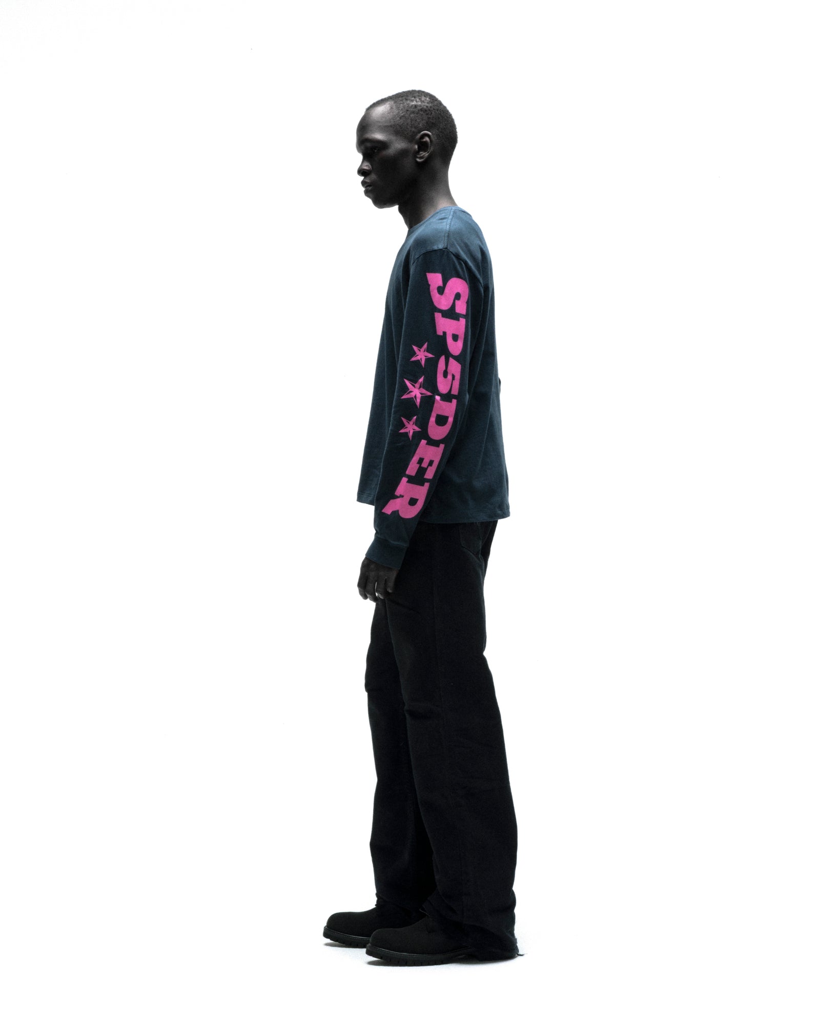Black model in a navy MX555 long sleeve tee with pink "SPSDER" graphic and stars on the sleeve.