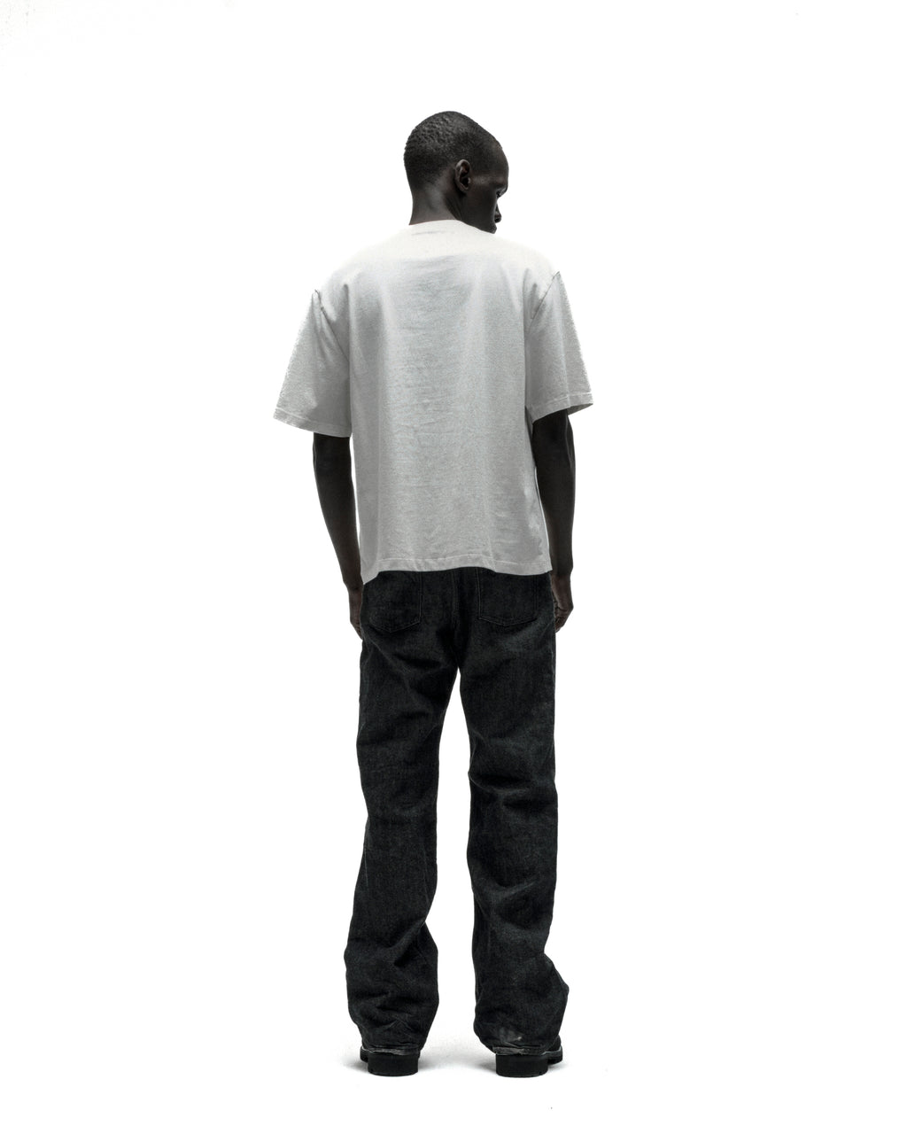 Man in a white, standard fit, 100% cotton lightweight tee with a graphic print on the front.