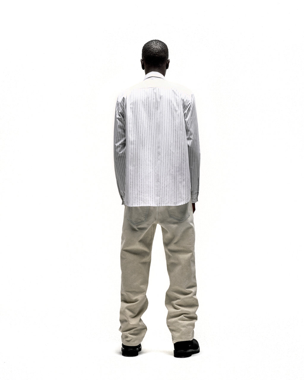Man from behind wearing a white 5-pinstripe woven cotton oxford button-down shirt with a spread collar.