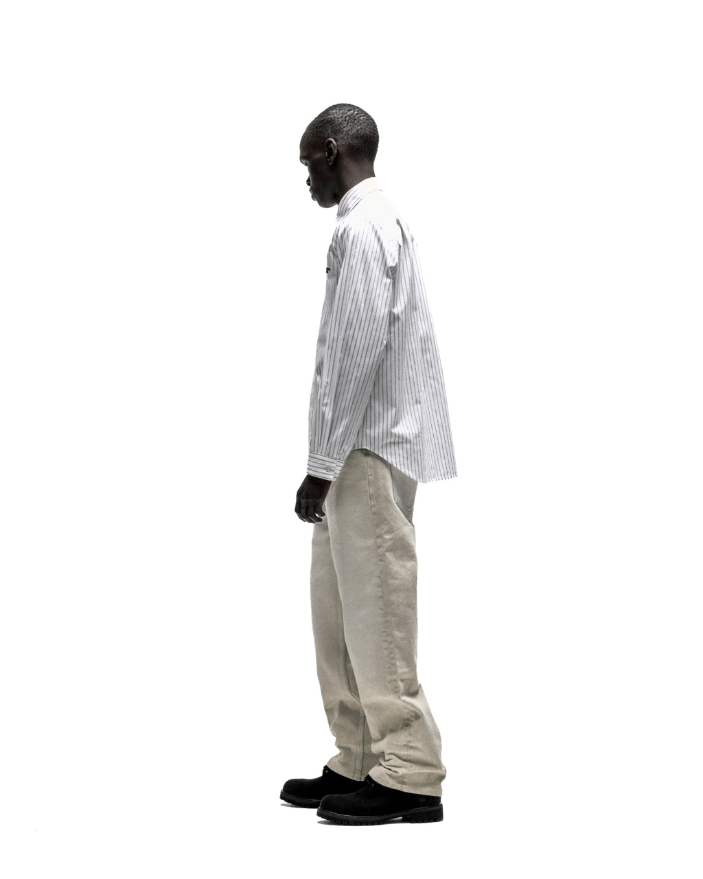 Man in R-05 Oxford Button Down: white woven cotton shirt with 5 pinstripes, embroidered logo, spread collar.
