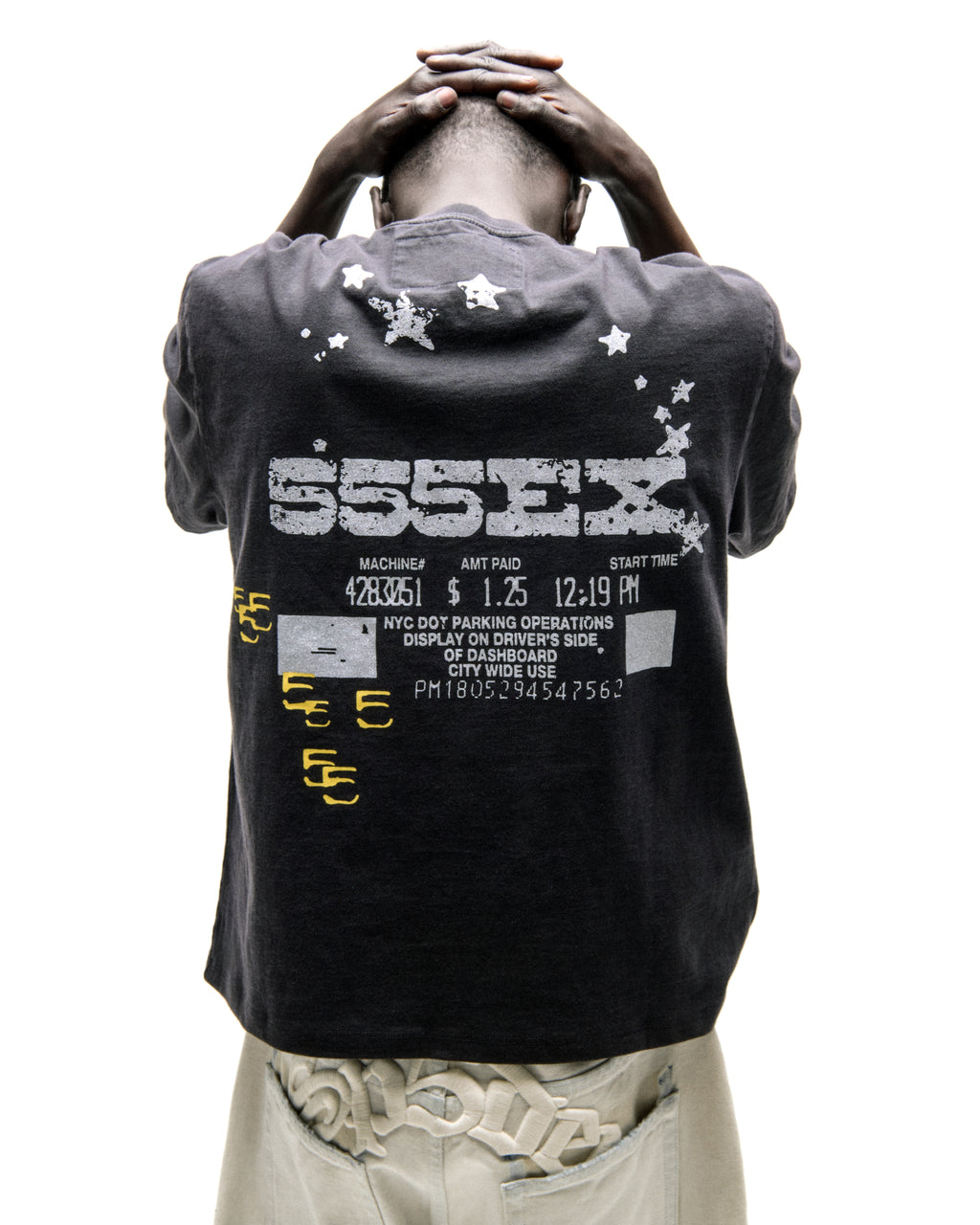 Back of a dark grey cotton ANNIVERSARY TEE with "ESSEX" and stars graphic, plus parking ticket details.