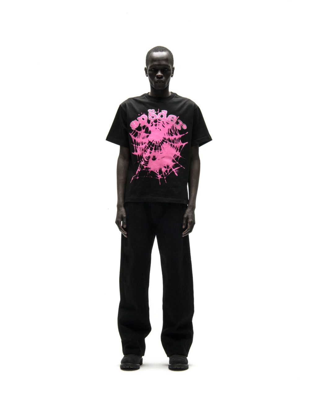 Black cotton tee with pink "SP5DER" text and spiderweb graphic, worn by a male model.
