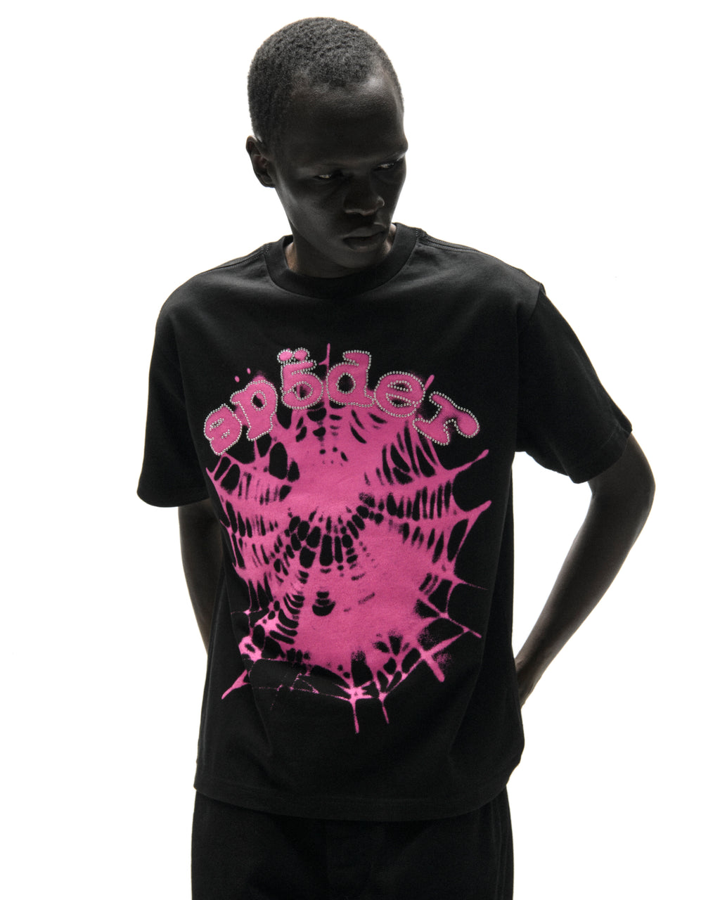 Black cotton tee with pink spiderweb graphic and "SP5DER" text lined with rhinestones.