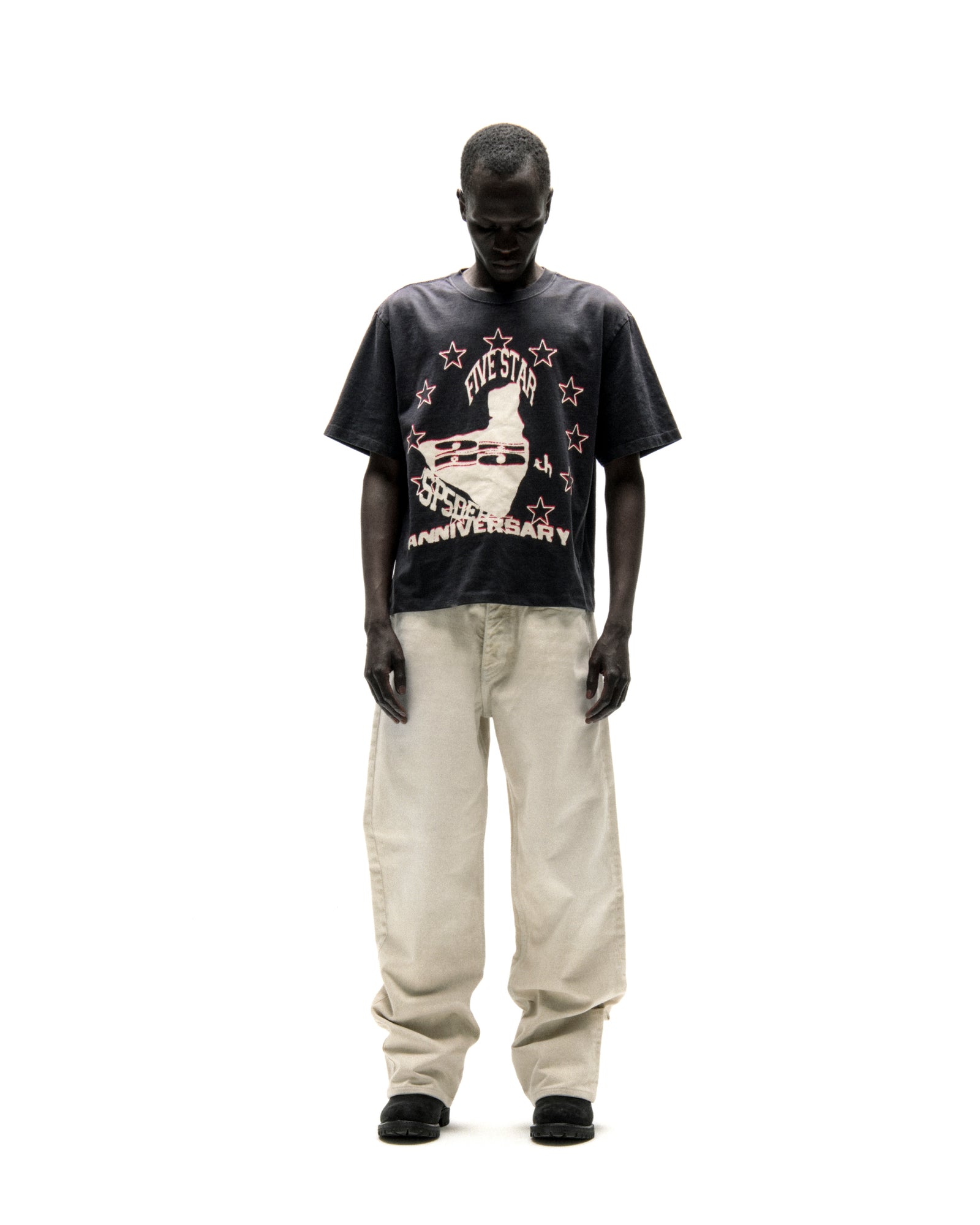 Black cotton ANNIVERSARY TEE with "FIVE STAR 25th ANNIVERSARY" graphic, worn by a man.